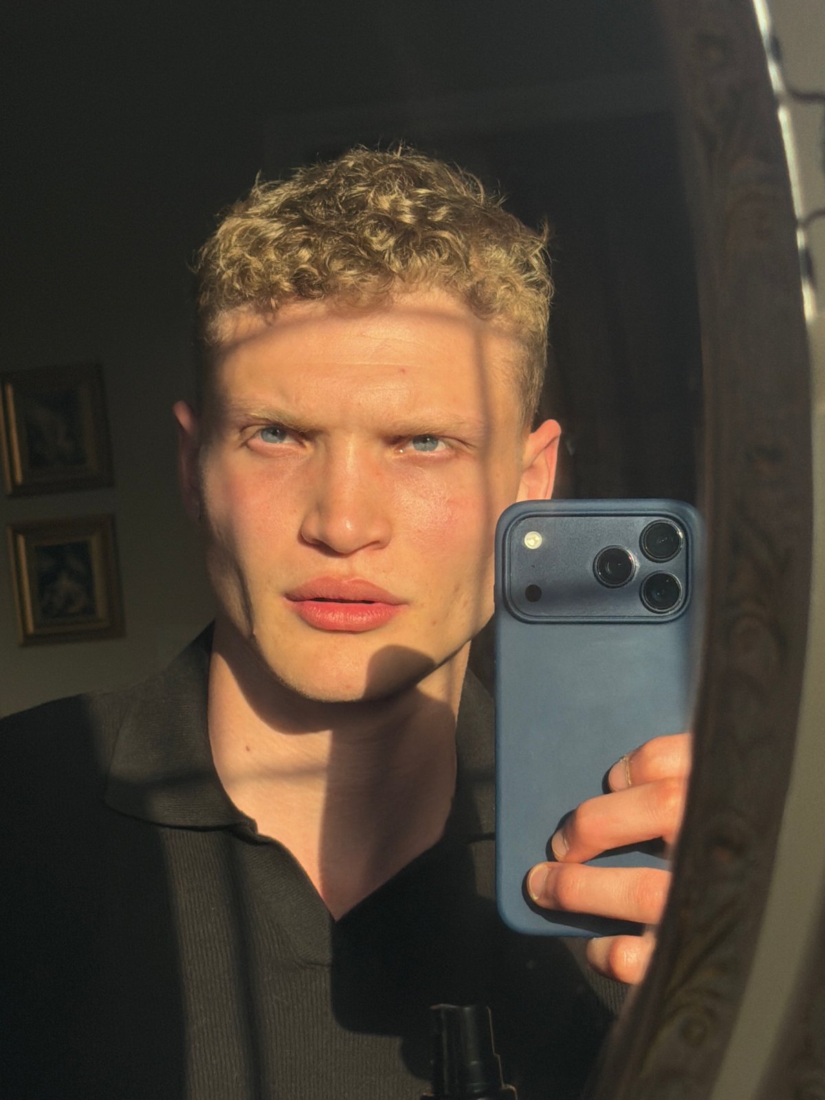 Person takes mirror selfie with smartphone in East Suffolk