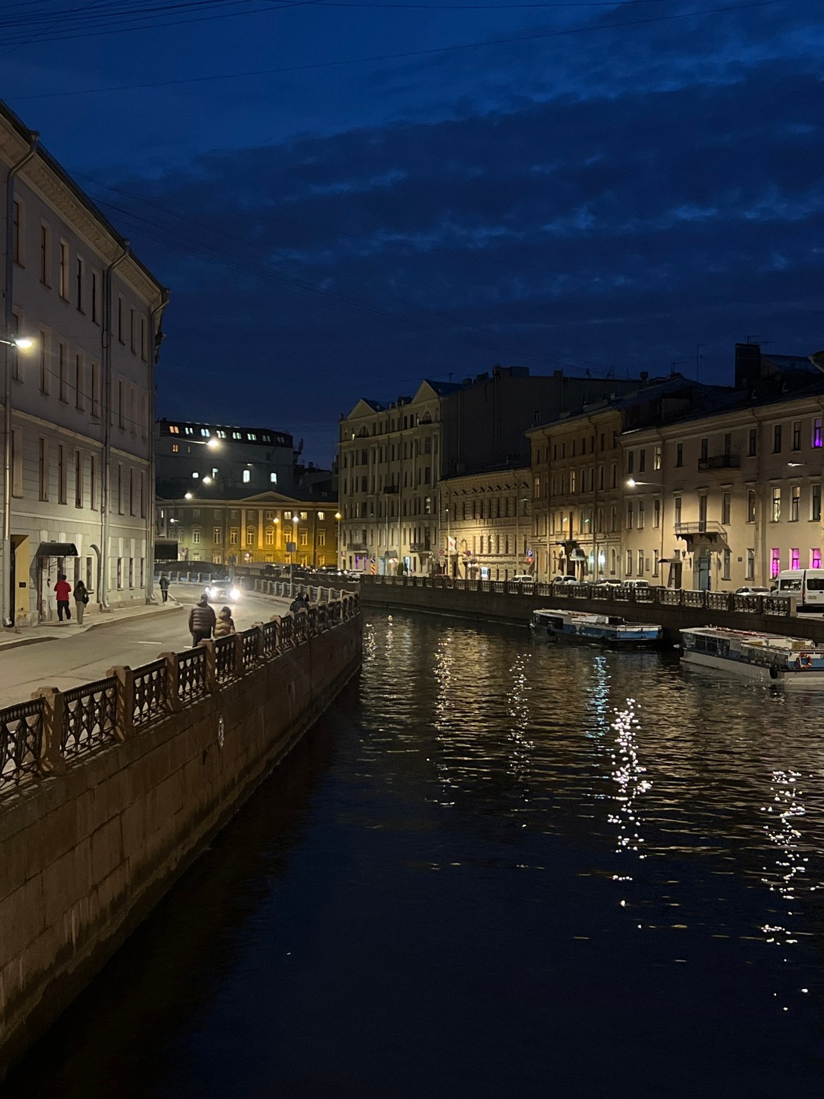 Evening lights reflect on Saint Petersburg canal waters