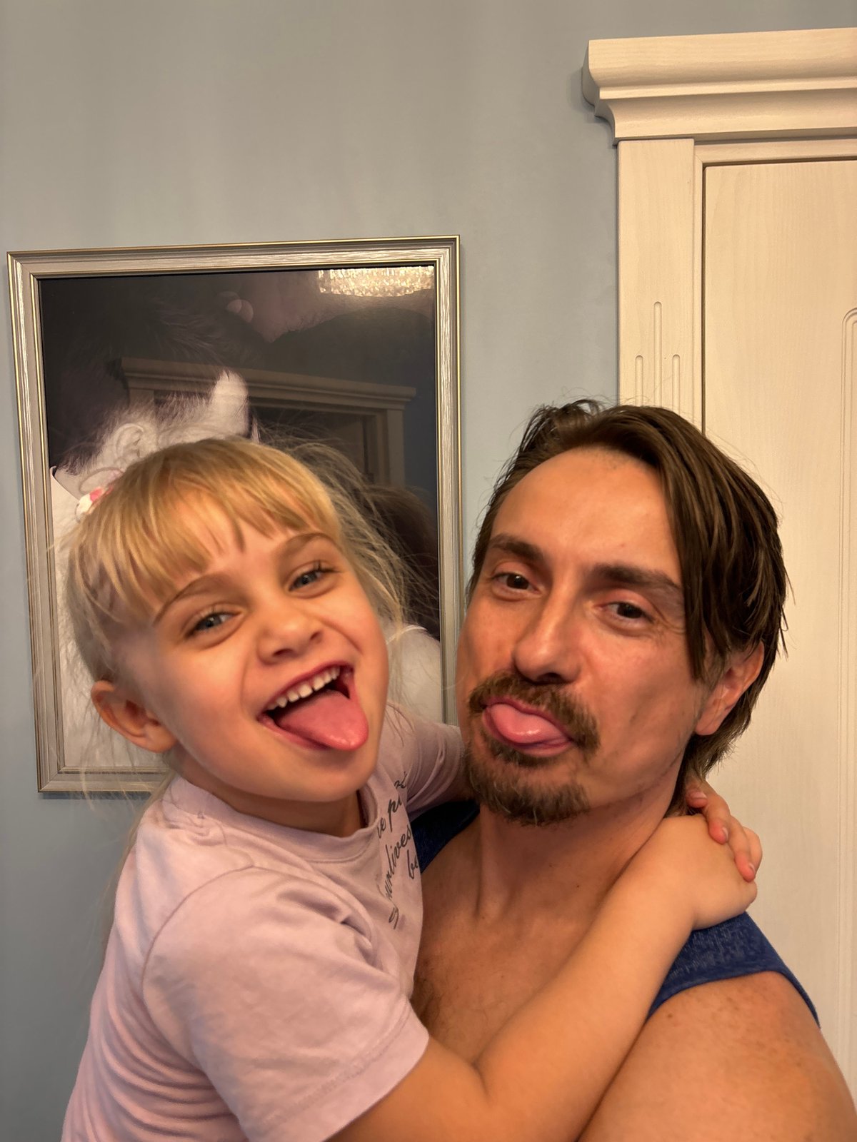 Father and daughter share playful moment in Sinyavino home