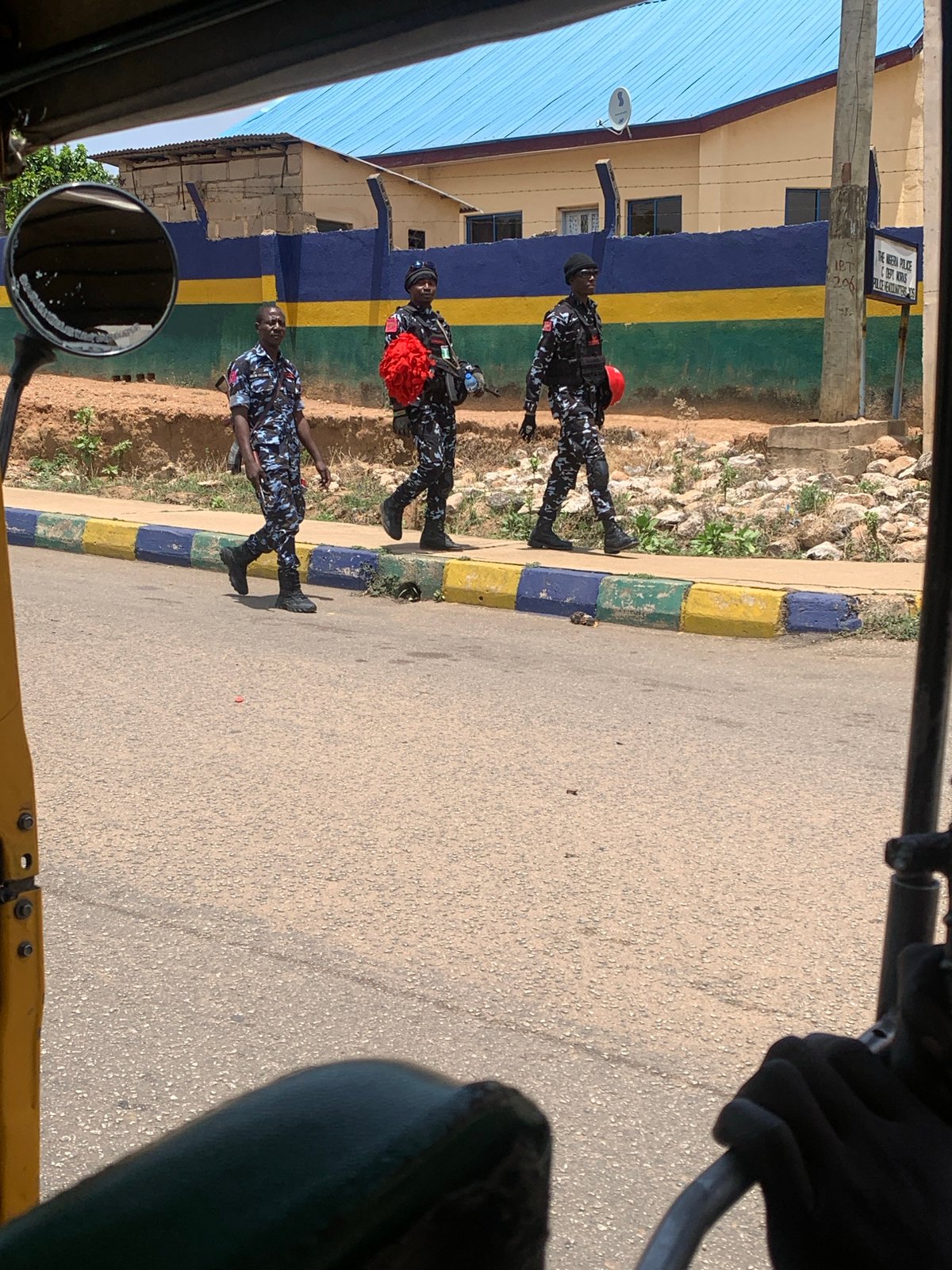 Armed police patrol Jos streets as loaded truck travels