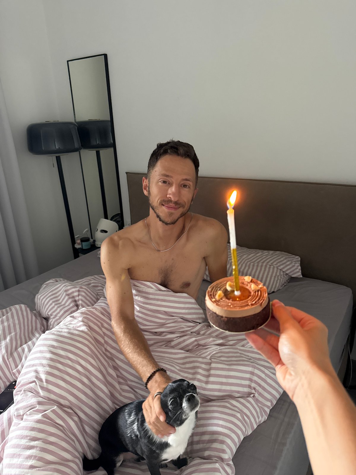 Chocolate cake with a candle, birthday morning in bed