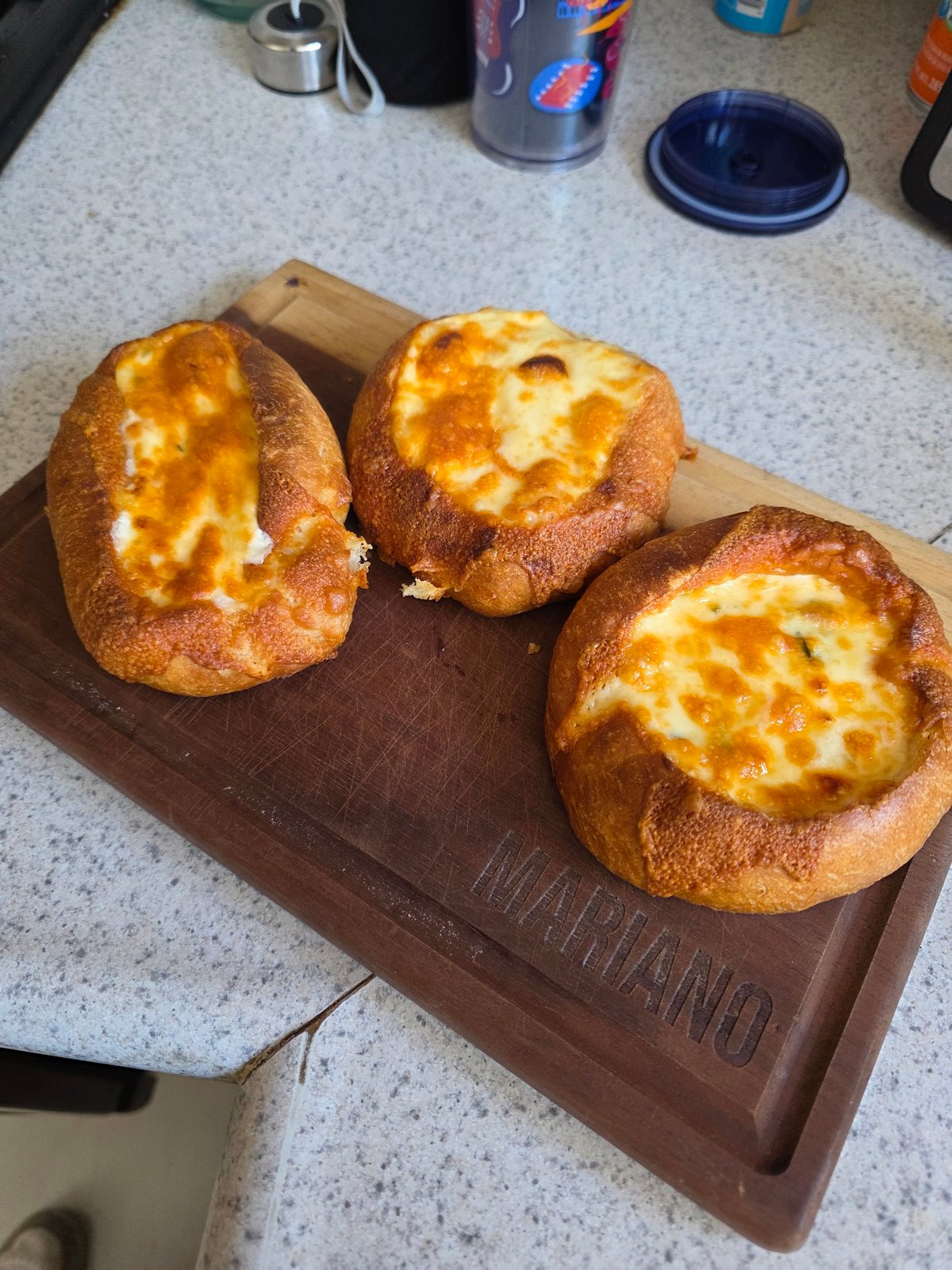Cheese-filled pastries documented on wooden board in Puebla
