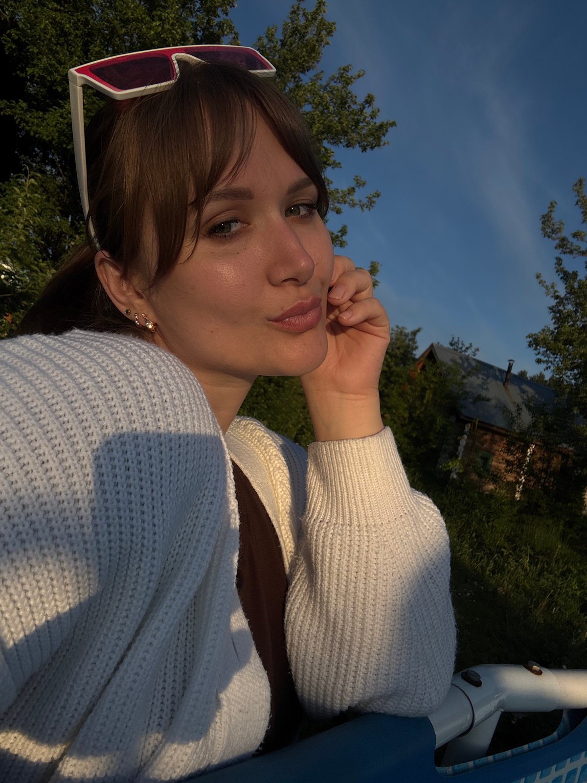 Woman enjoys poolside relaxation during golden hour in Chaikovsky