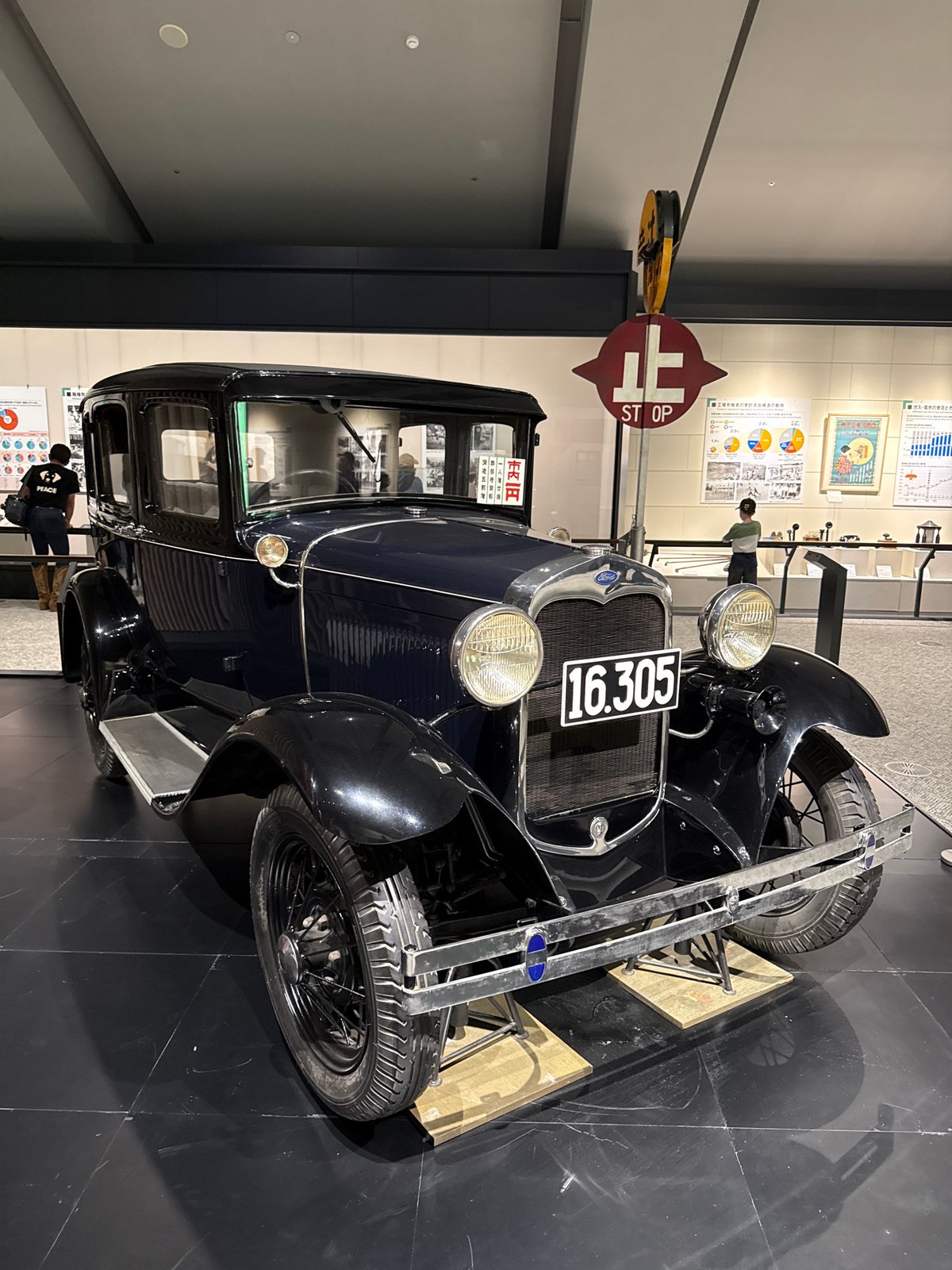 Antique blue Ford displayed in museum exhibition hall