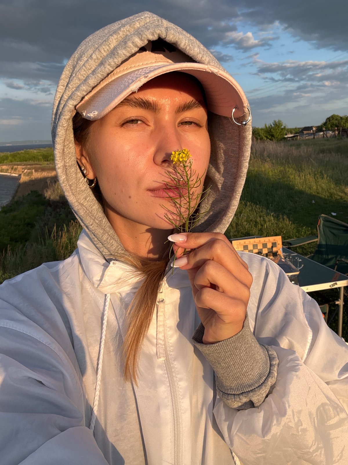 Woman takes golden hour selfies at scenic overlook