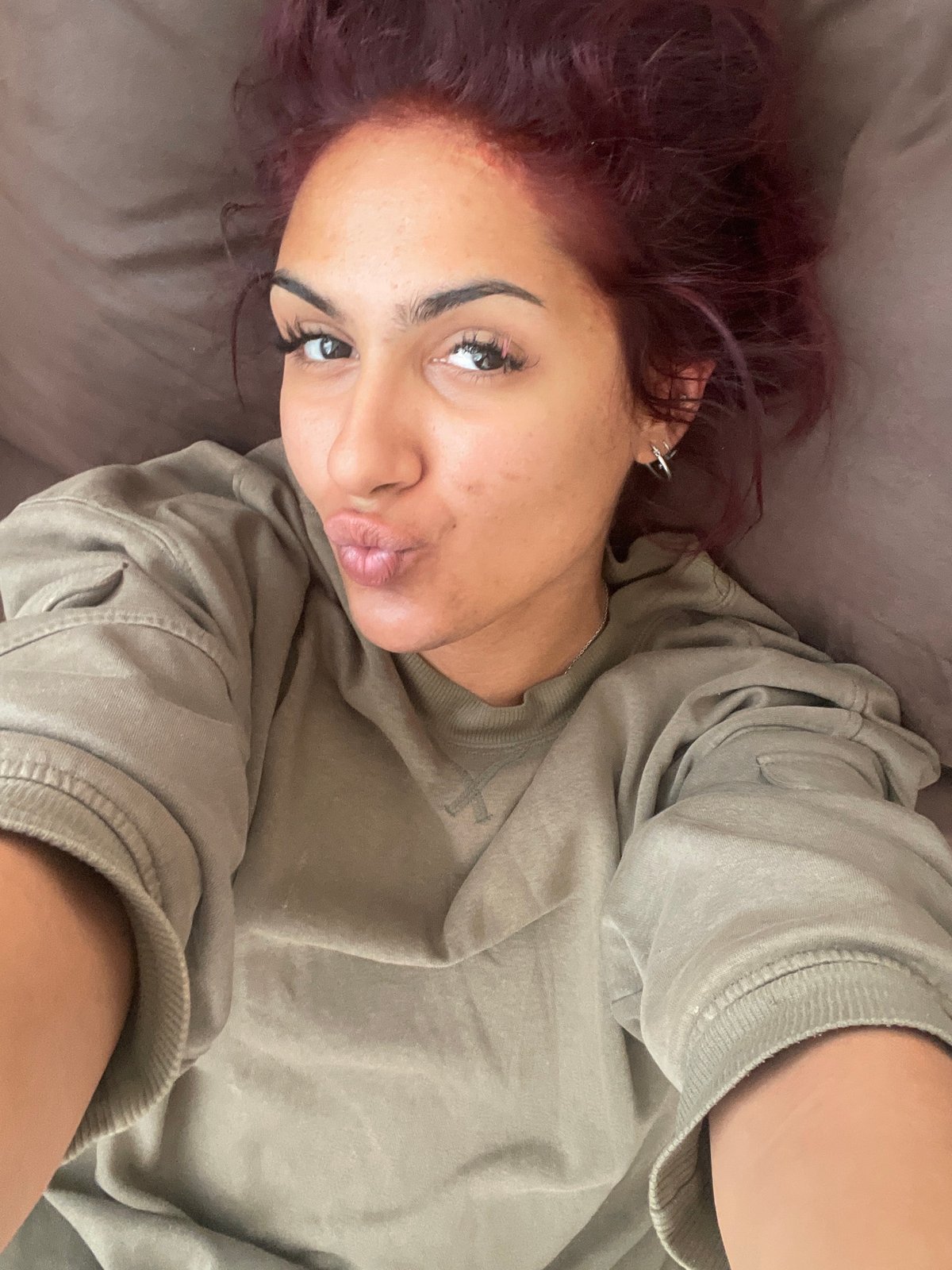 Woman with purple hair spotted with chocolate bunny