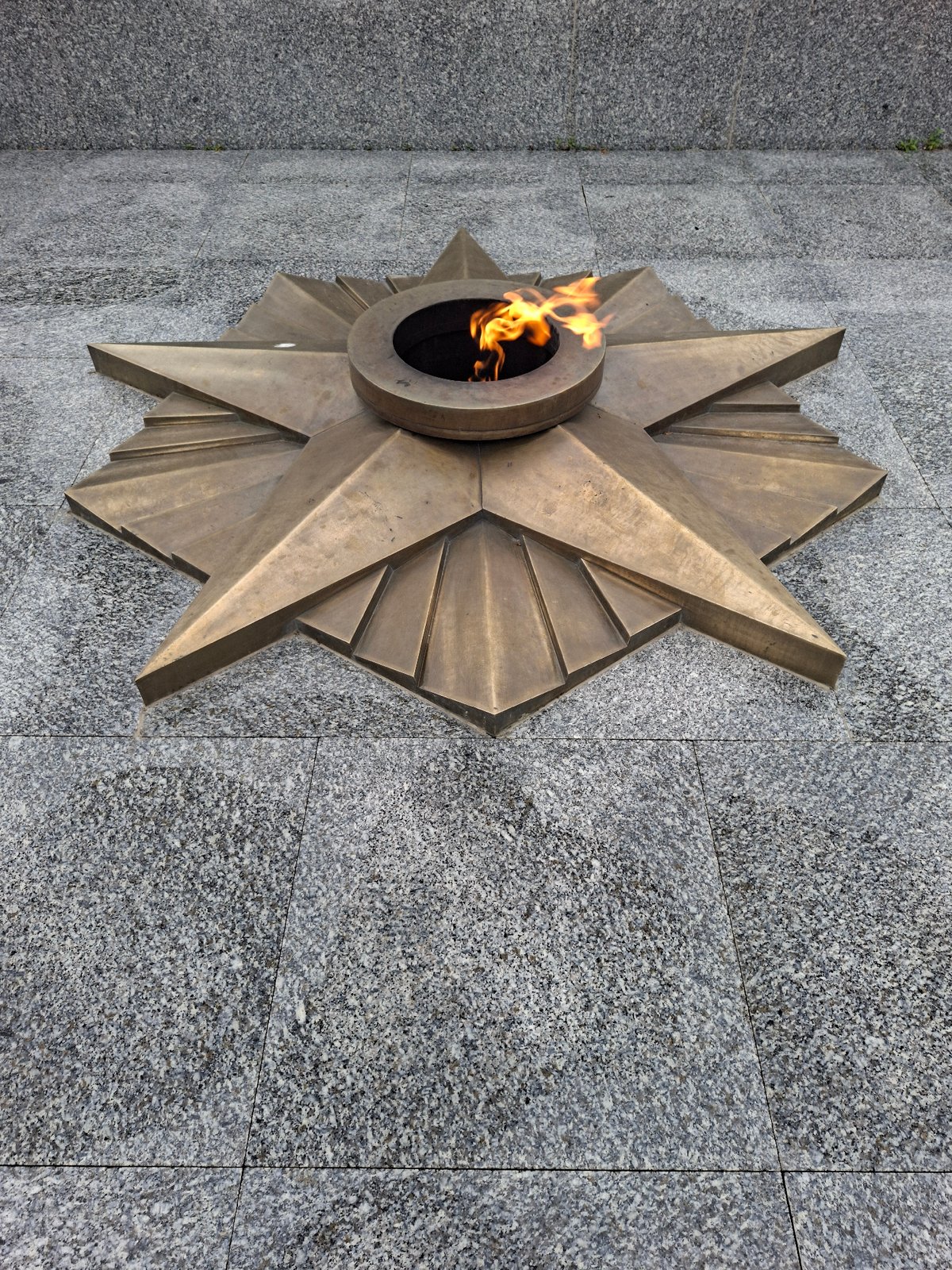 Kokshetau memorial park: wet flowers, fountain, and war monument