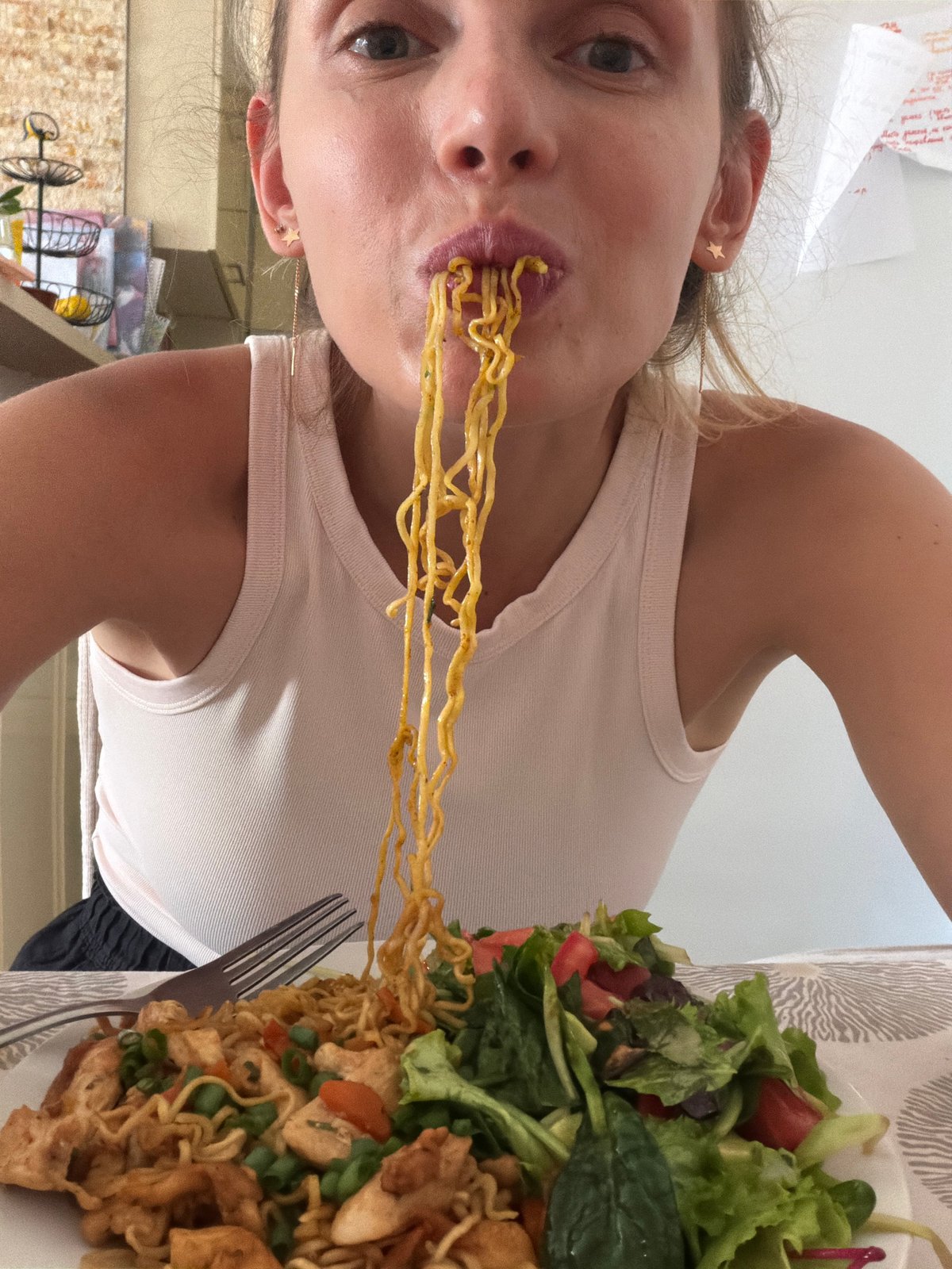 Woman enjoys noodle lunch in Budva restaurant