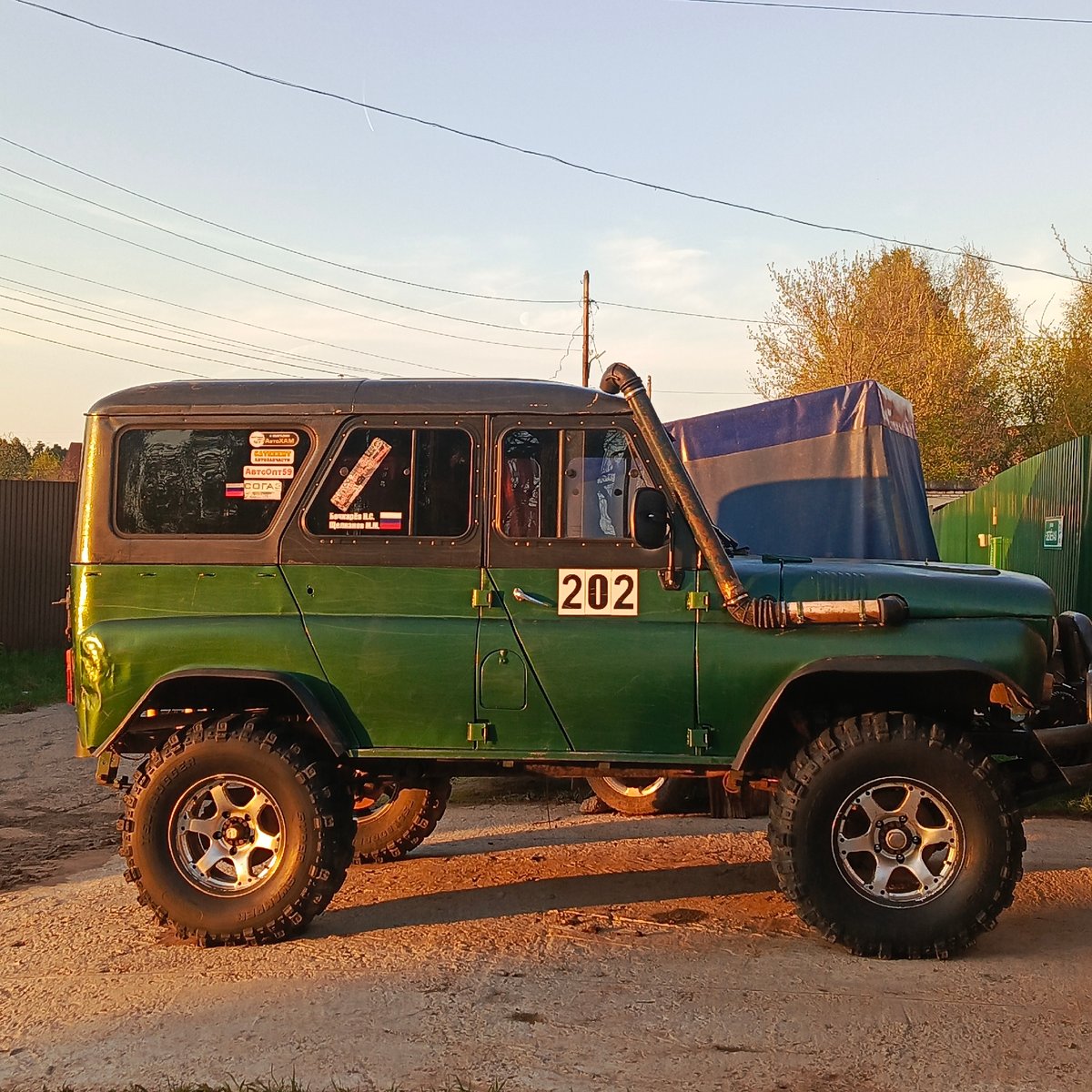Woman takes sunset selfies near military vehicle in Chaikovsky