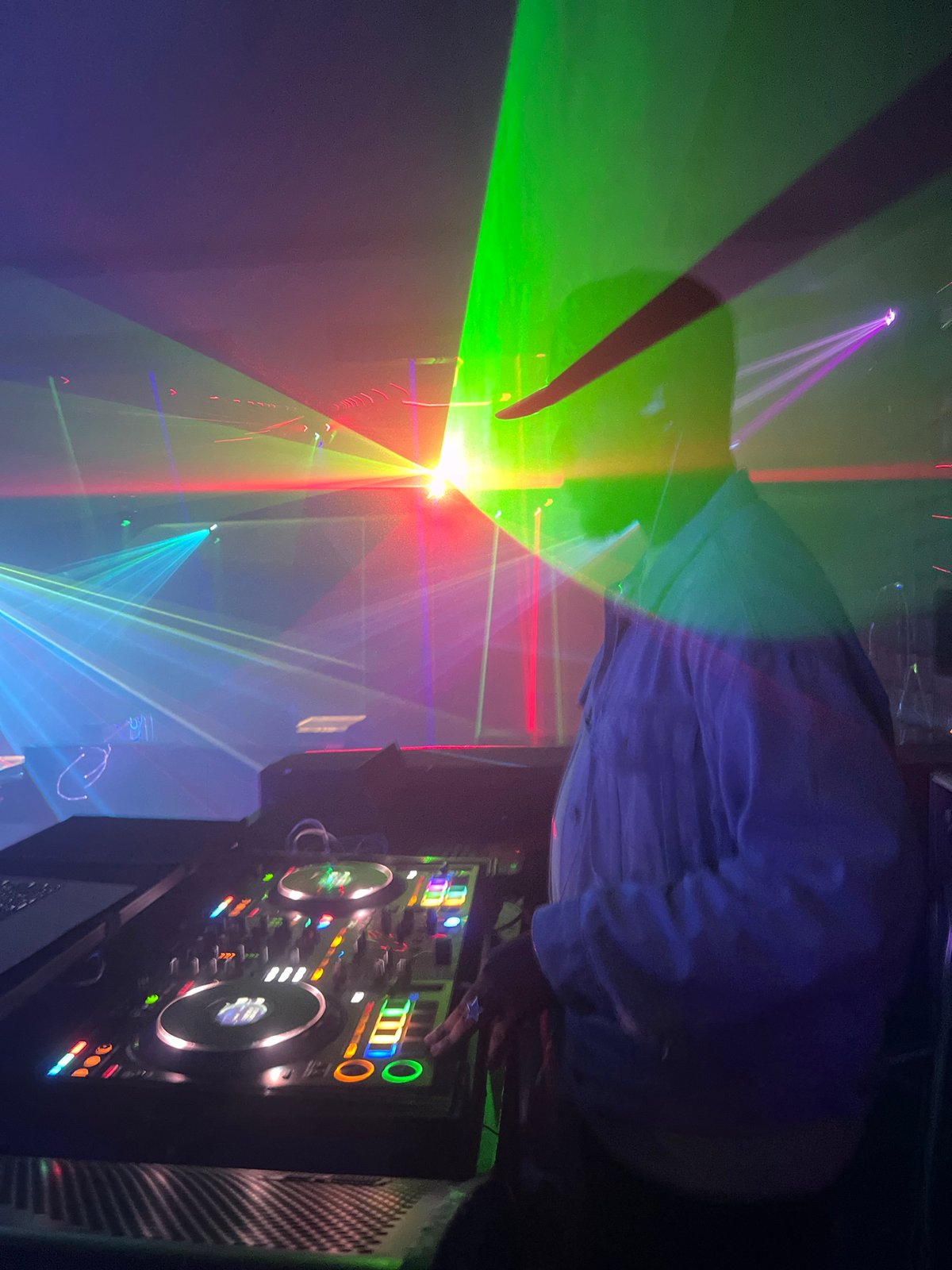 DJ performs with colorful laser light show at club