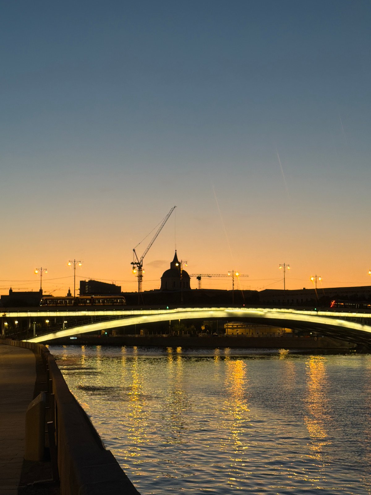Passenger boat cruises the Moscow River at golden hour
