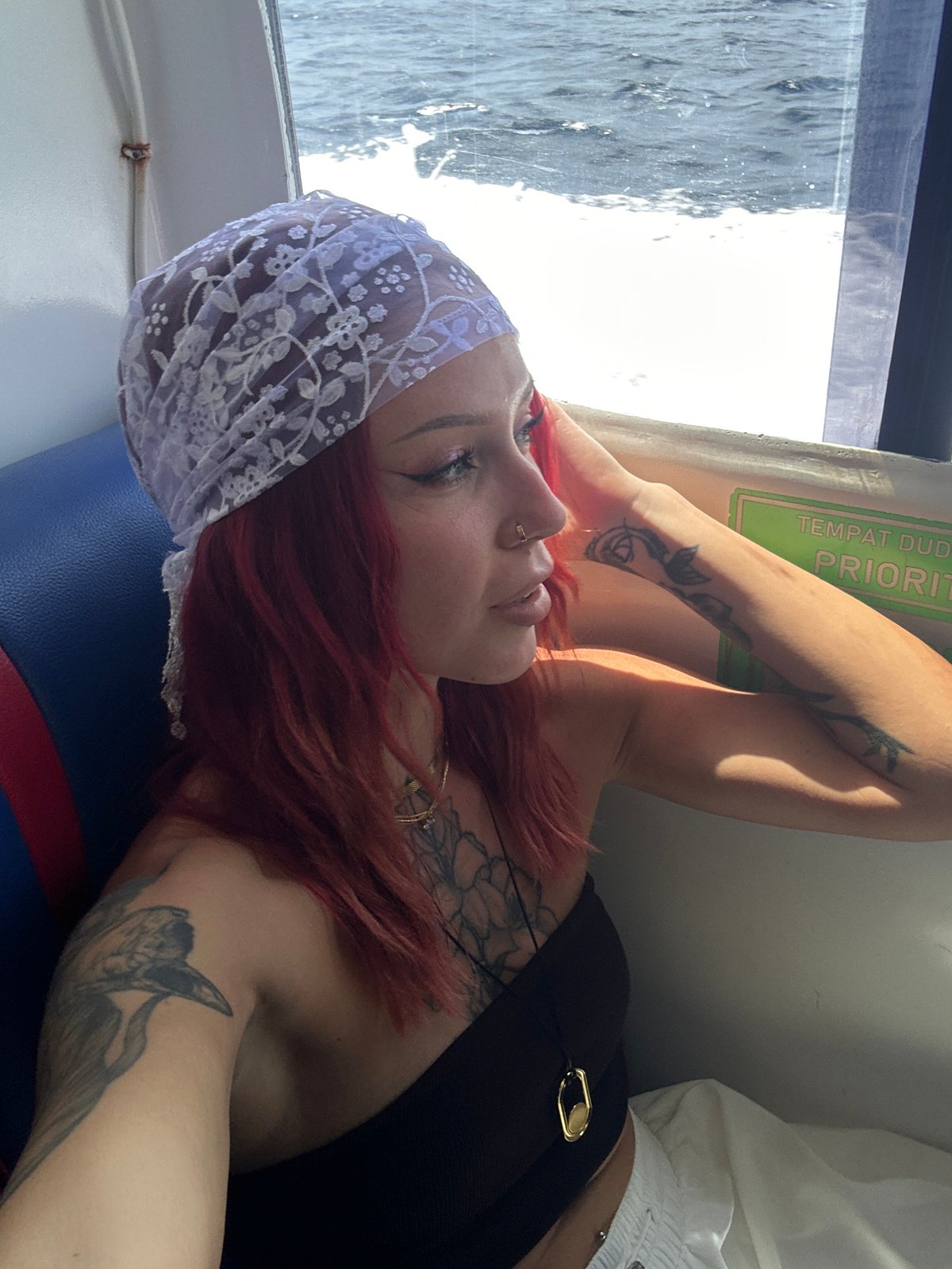 Tattooed woman photographed resting aboard Indonesian ferry