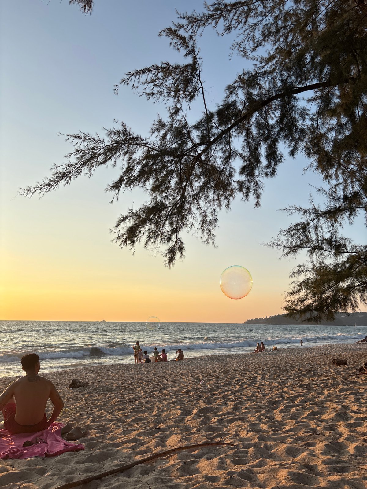 Person observed at sunset beach scene in Choeng Thale