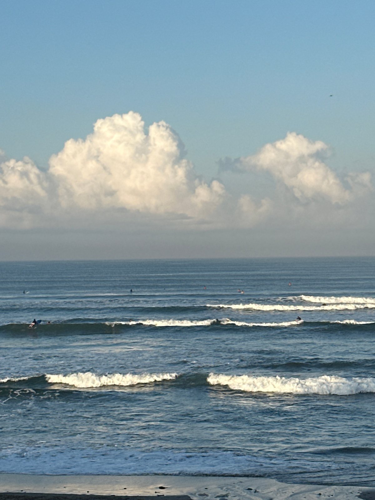 Surf culture and beach life on North Kuta's dark sand shores