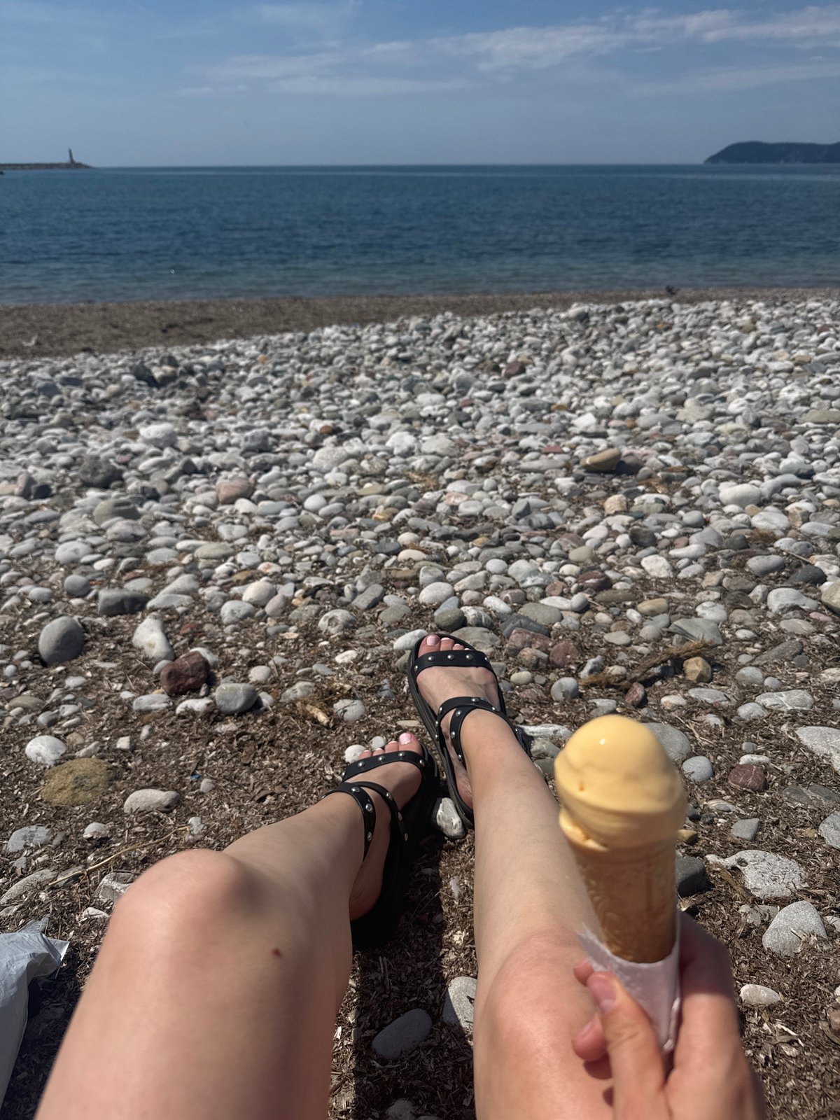 Person enjoys sunny afternoon at Bar Montenegro beach promenade