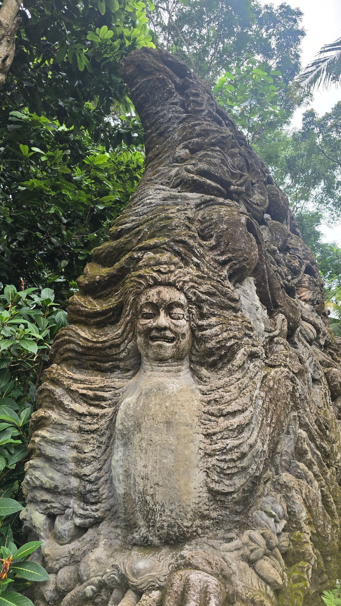 Ancient stone sculptures documented in Ubud forest setting