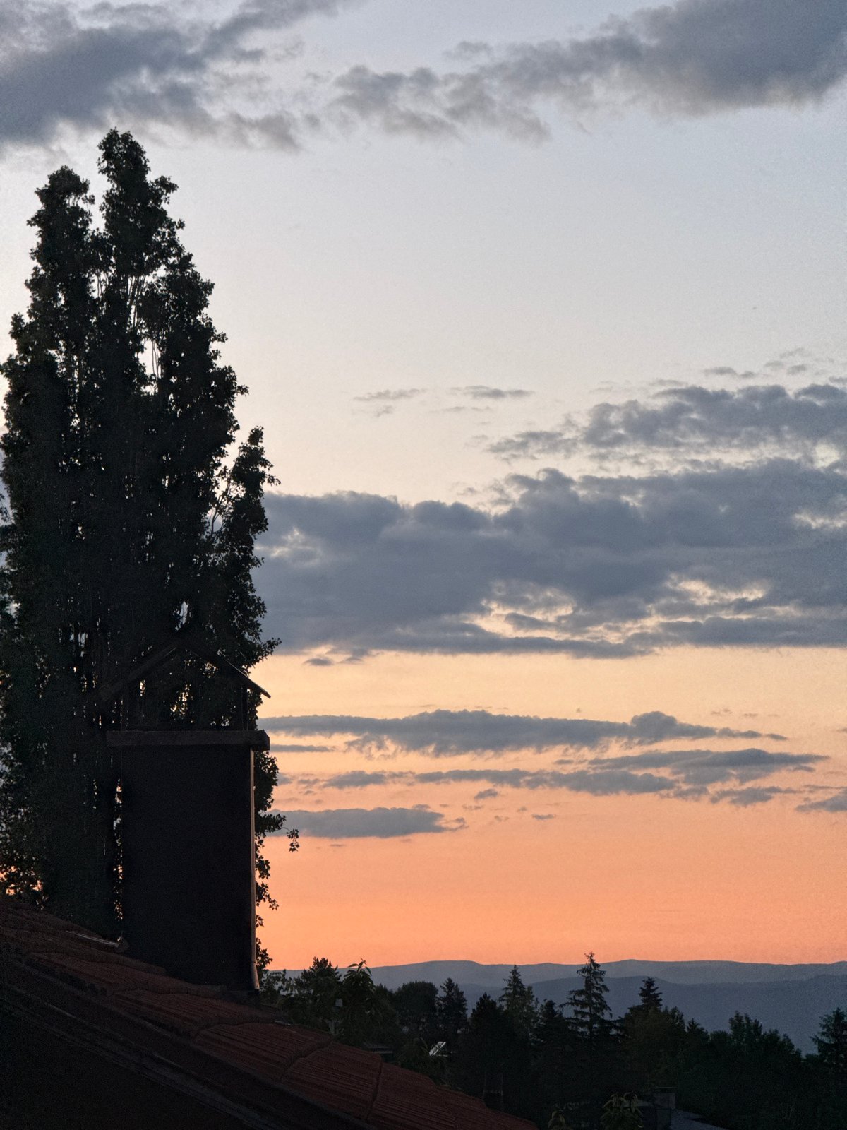 Sunset captured over Sofia residential rooftops June evening