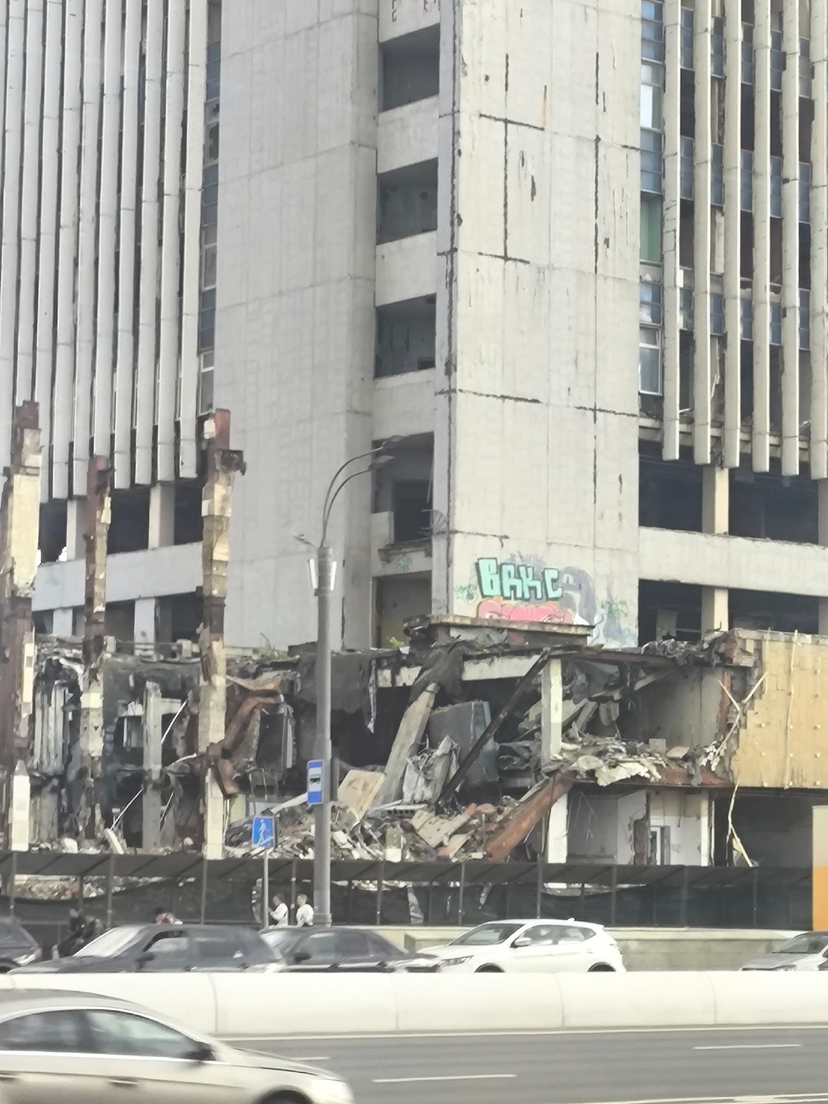 Brutalist building comes down while pigeons gather nearby