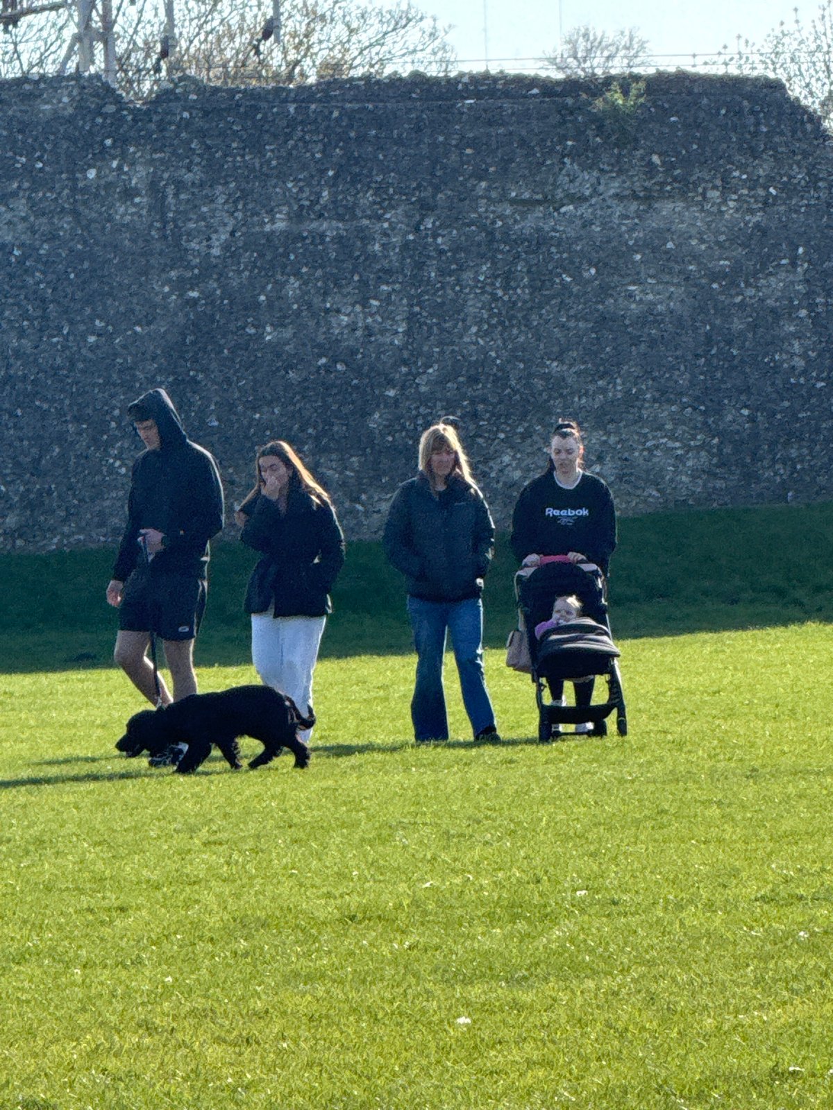 Family visits historic Berkhamsted Castle on sunny afternoon