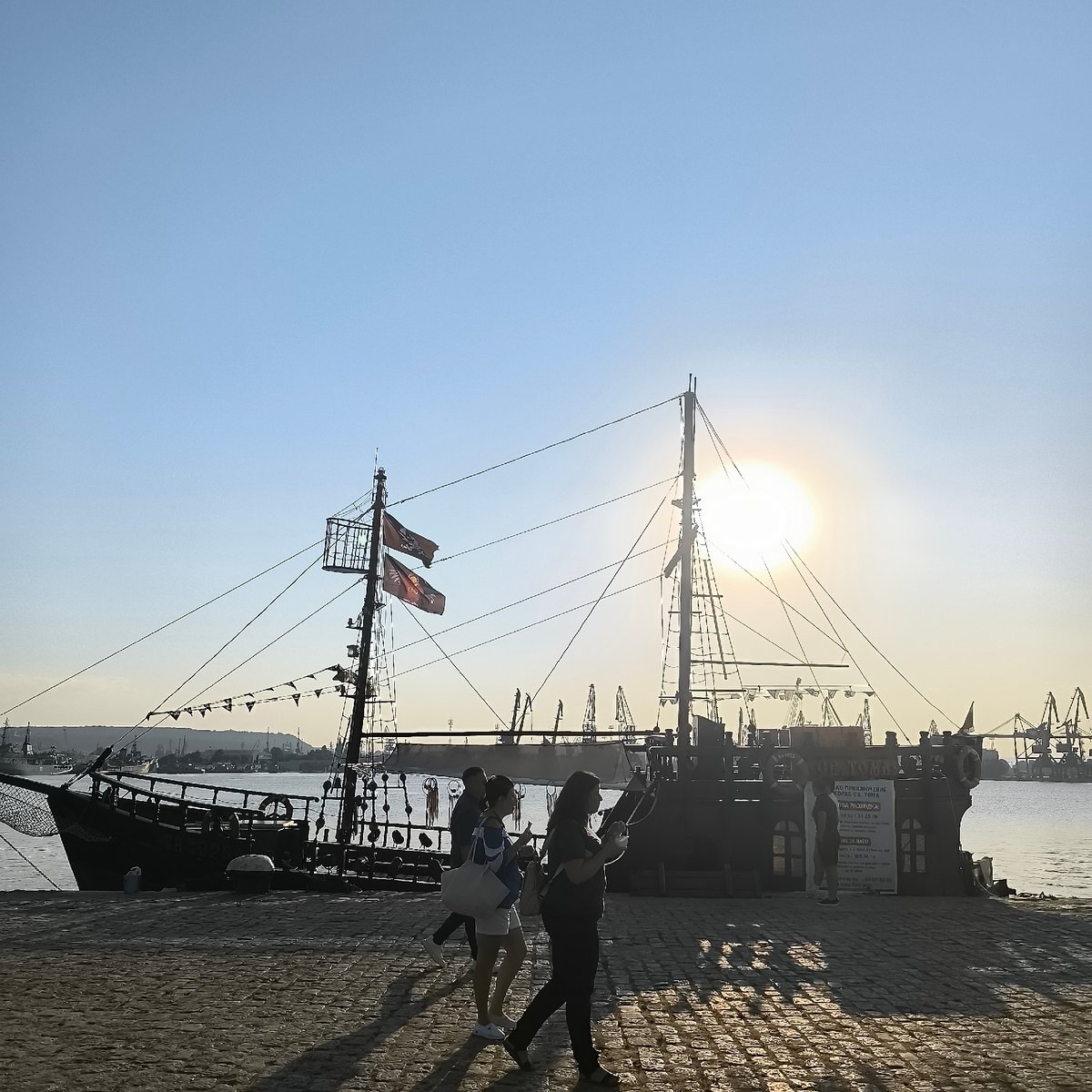 Sunset at Varna Port: ships, cranes, cats, and fairground rides