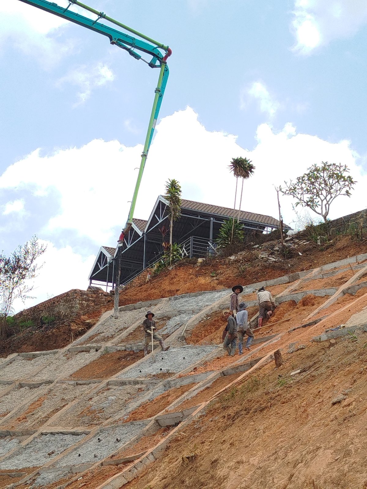 Construction crew works on terraced slope in Đa Thọ