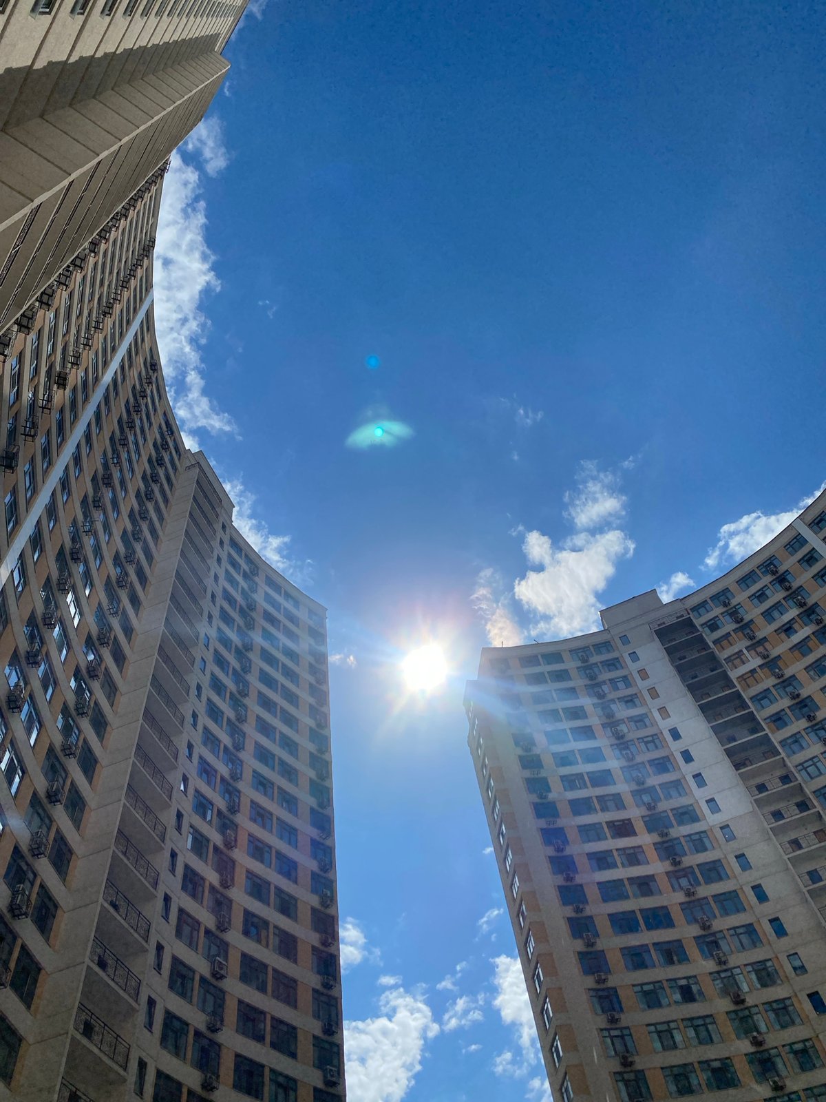 Modern apartment complex courtyard in Odesa on sunny afternoon