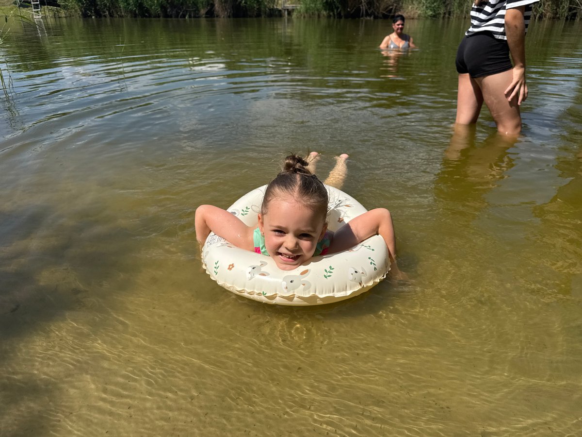 Swimming in a calm natural waterway near Pidhorodnie on a summer day
