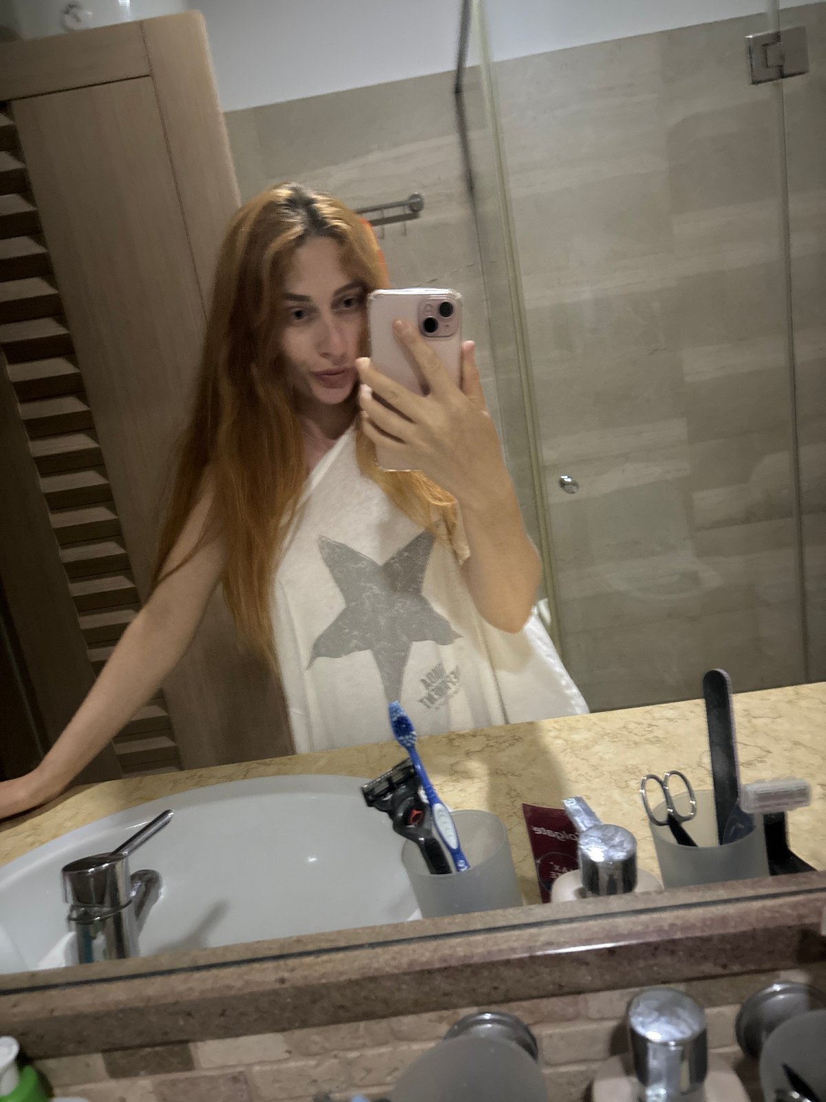 Woman Documents Evening Through Bathroom Mirror Selfies in Budva
