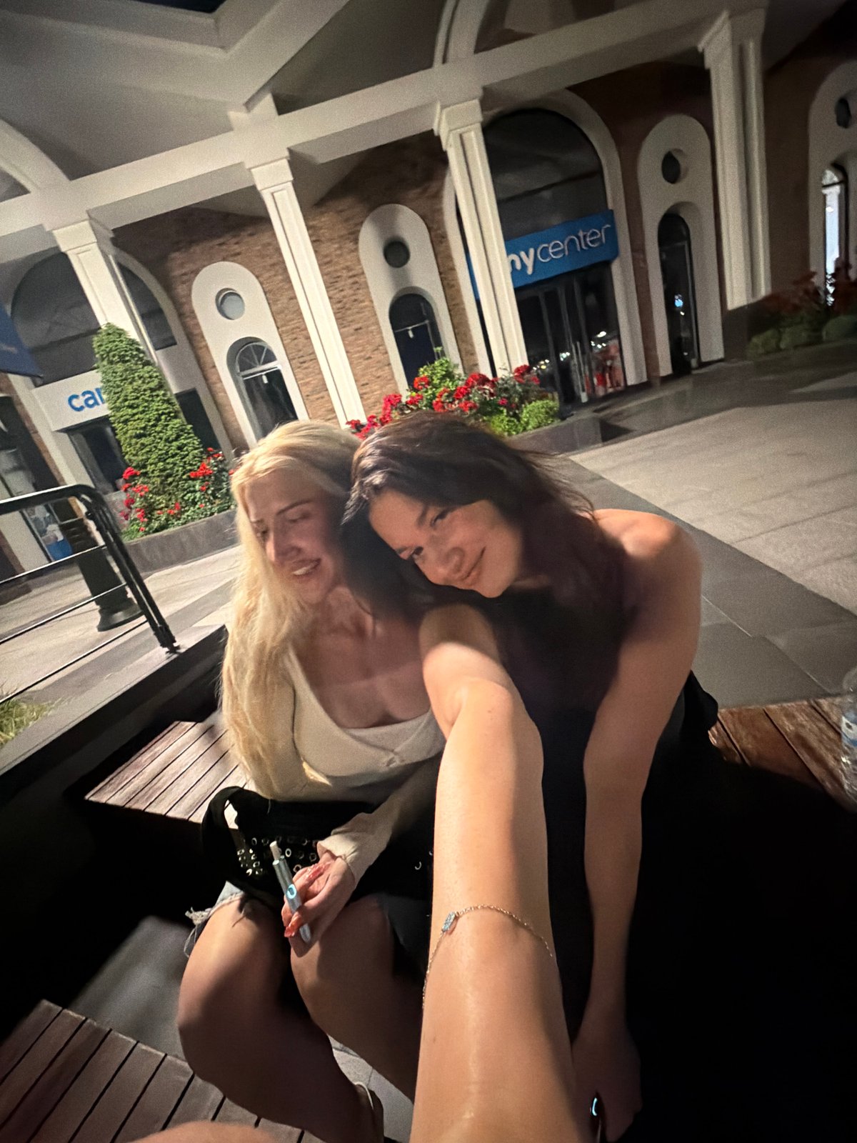 Two women photograph nighttime outing in Küçükçekmece waterfront district
