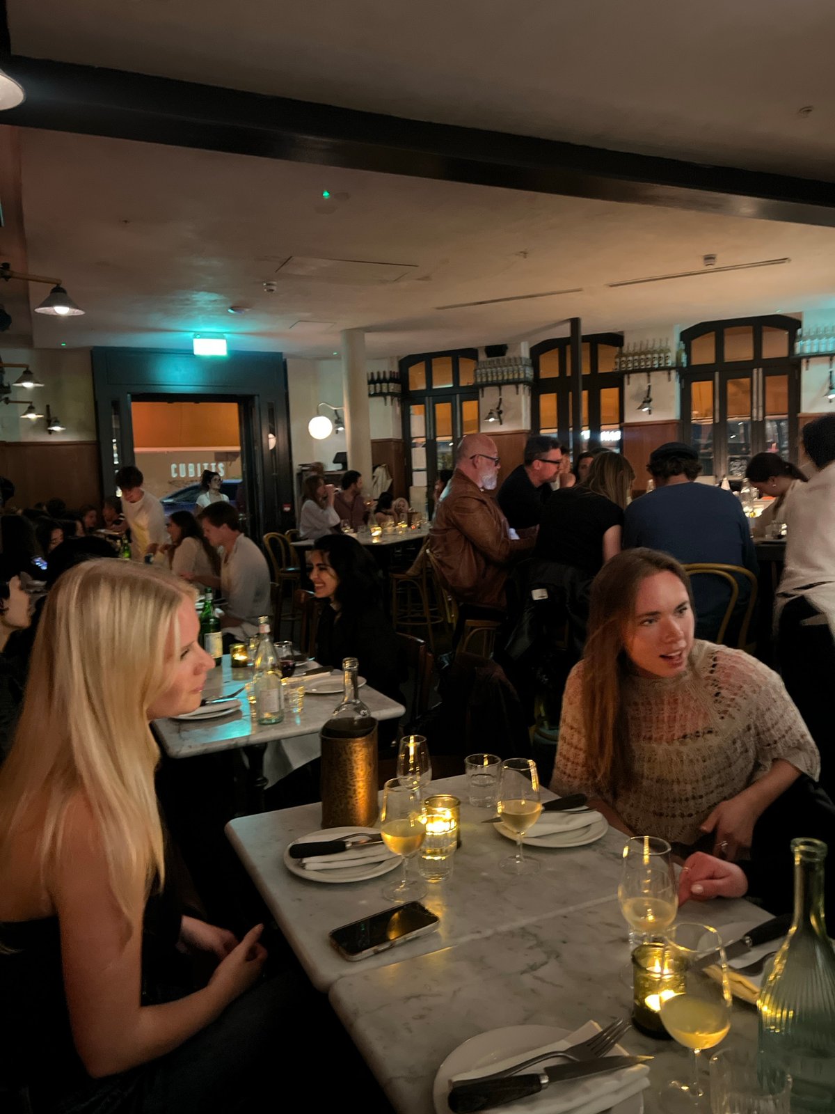 Busy restaurant scene captured in London during evening hours