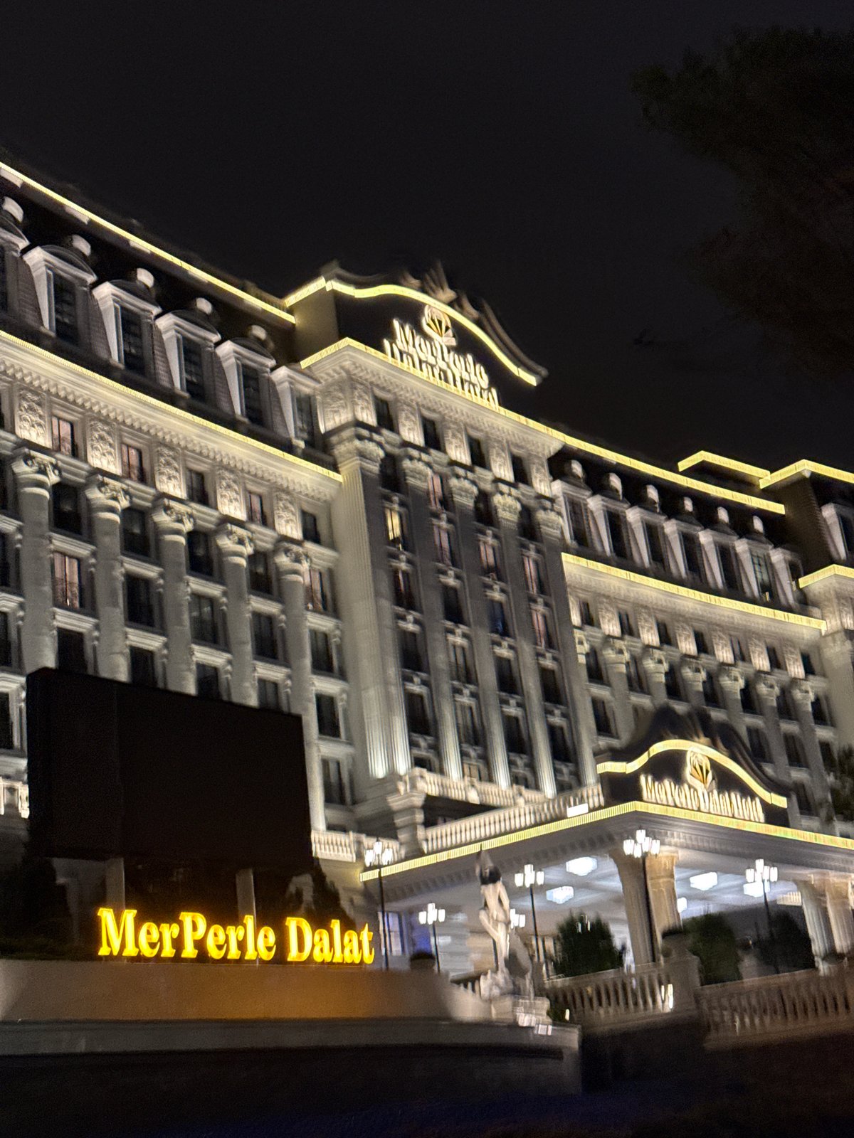 MerPerle Dalat Hotel glowing at night in Da Lat