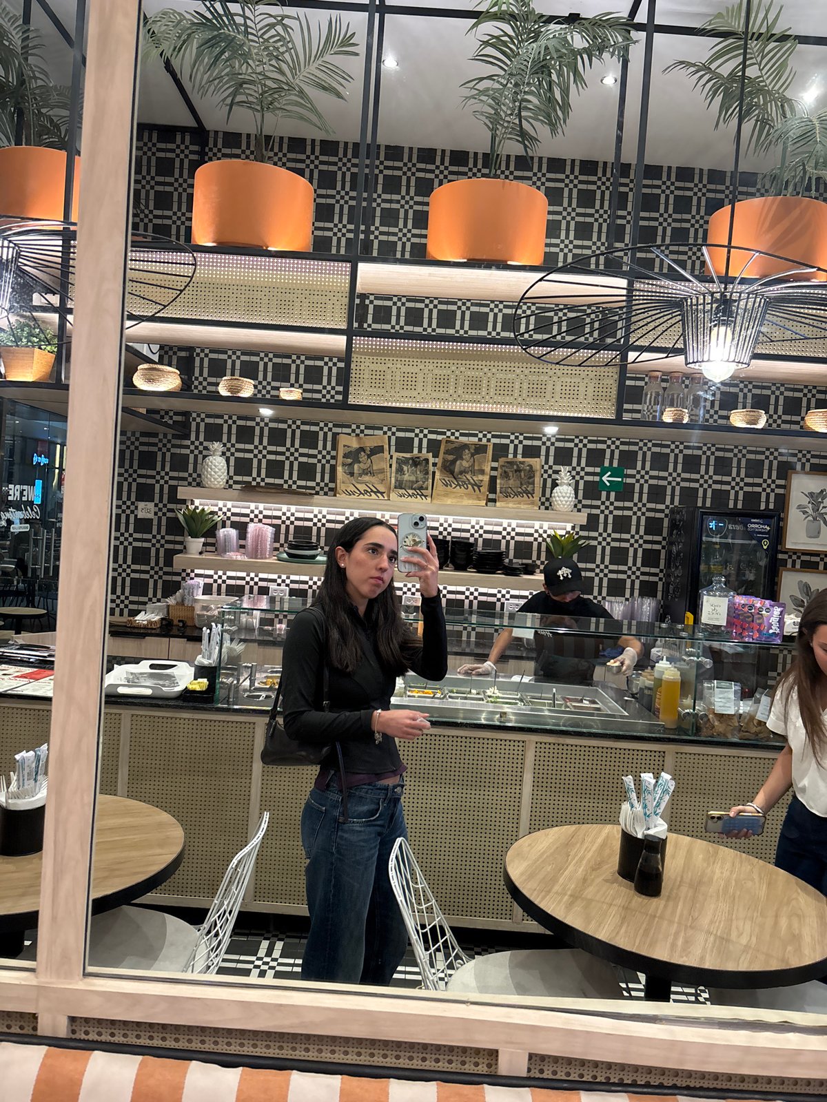 Restaurant customer photos display while worker prepares food