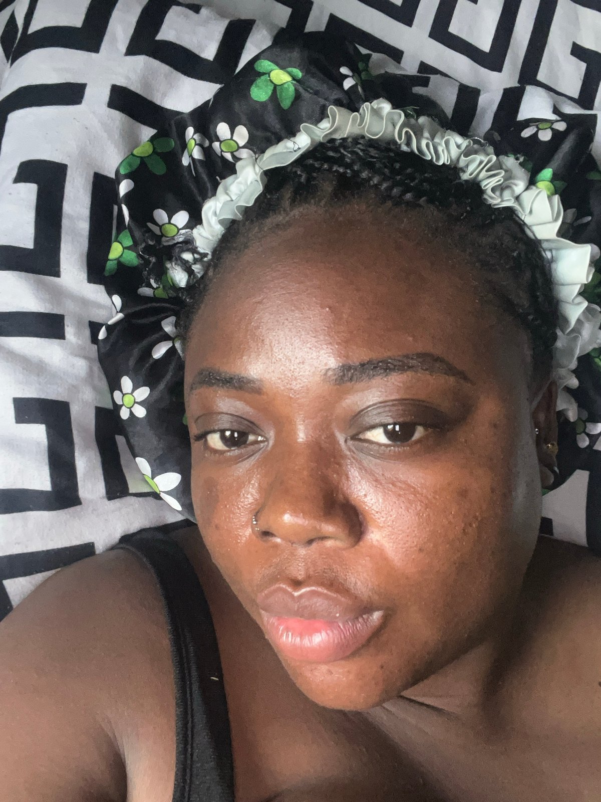Woman takes multiple selfies wearing floral bonnet in Abuja