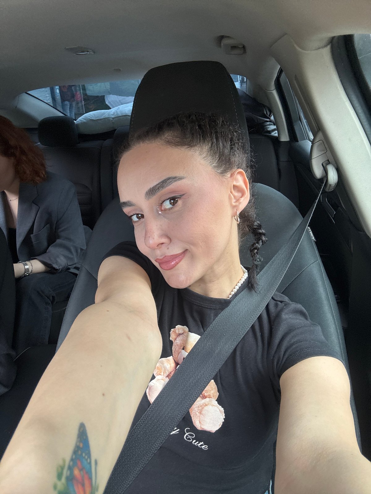 Woman in teddy bear shirt observed in car, Tbilisi