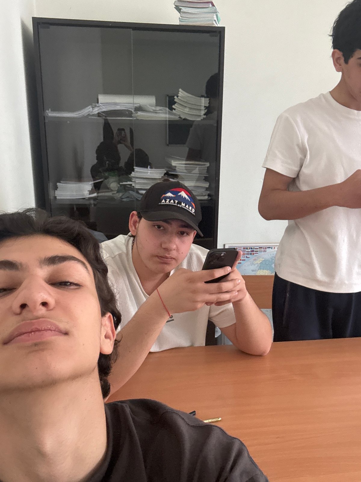 Person using smartphone captured from multiple angles in Yerevan classroom