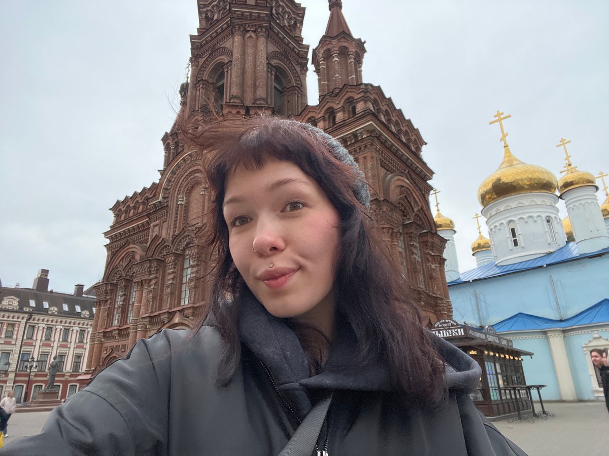 Woman takes upside-down selfie near historic building in Kazan