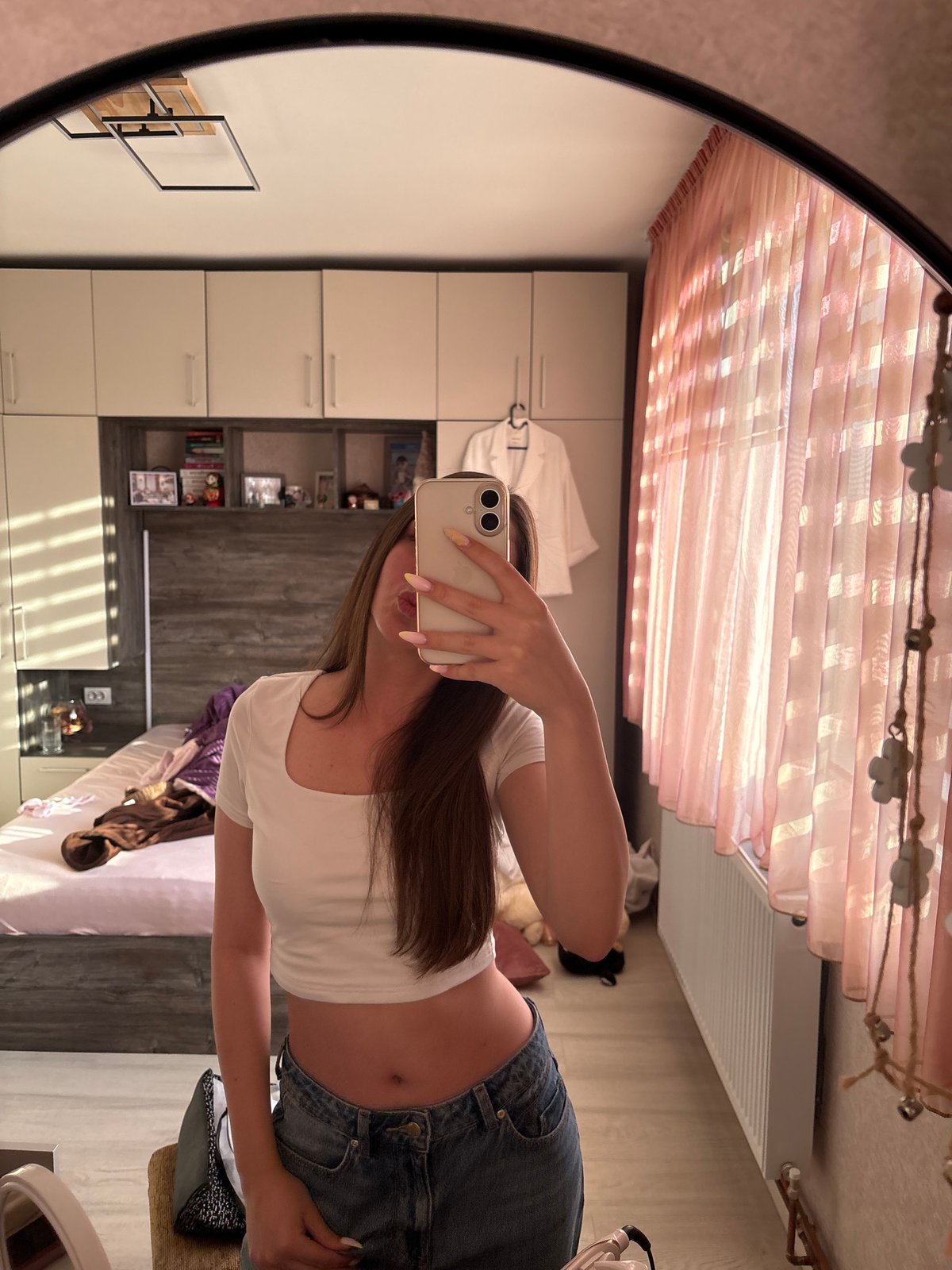 Woman takes mirror selfies in bedroom, Bulgarovo Bulgaria