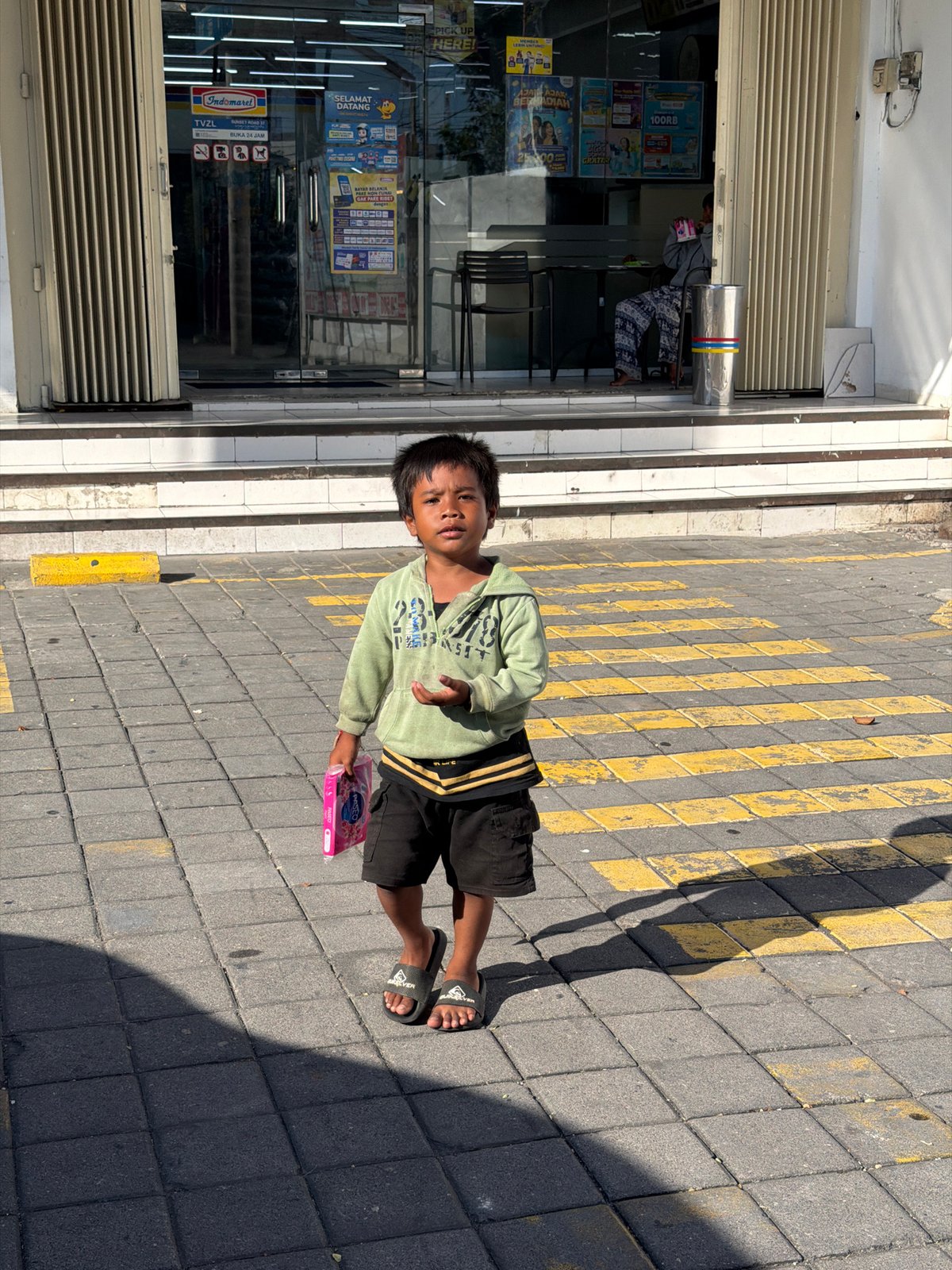 Morning street and storefront activity in Kuta, Bali