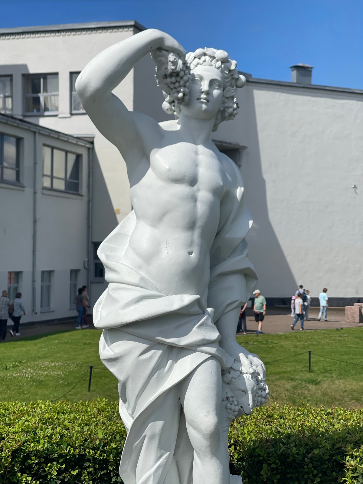Classical statues and summer crowds at a Vyborg park
