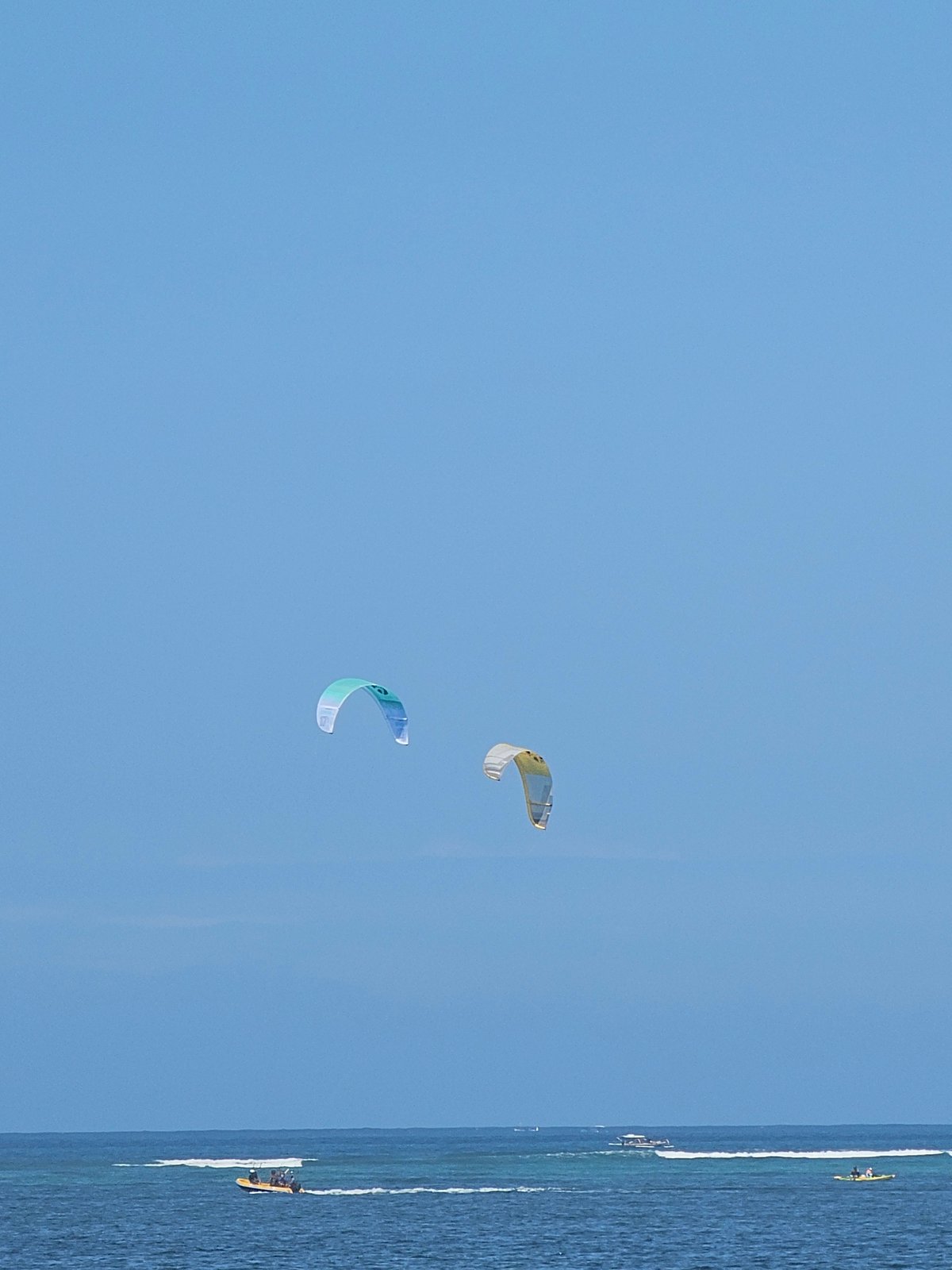 Kites, kitesurfers, and beachside massages at Sanur Beach