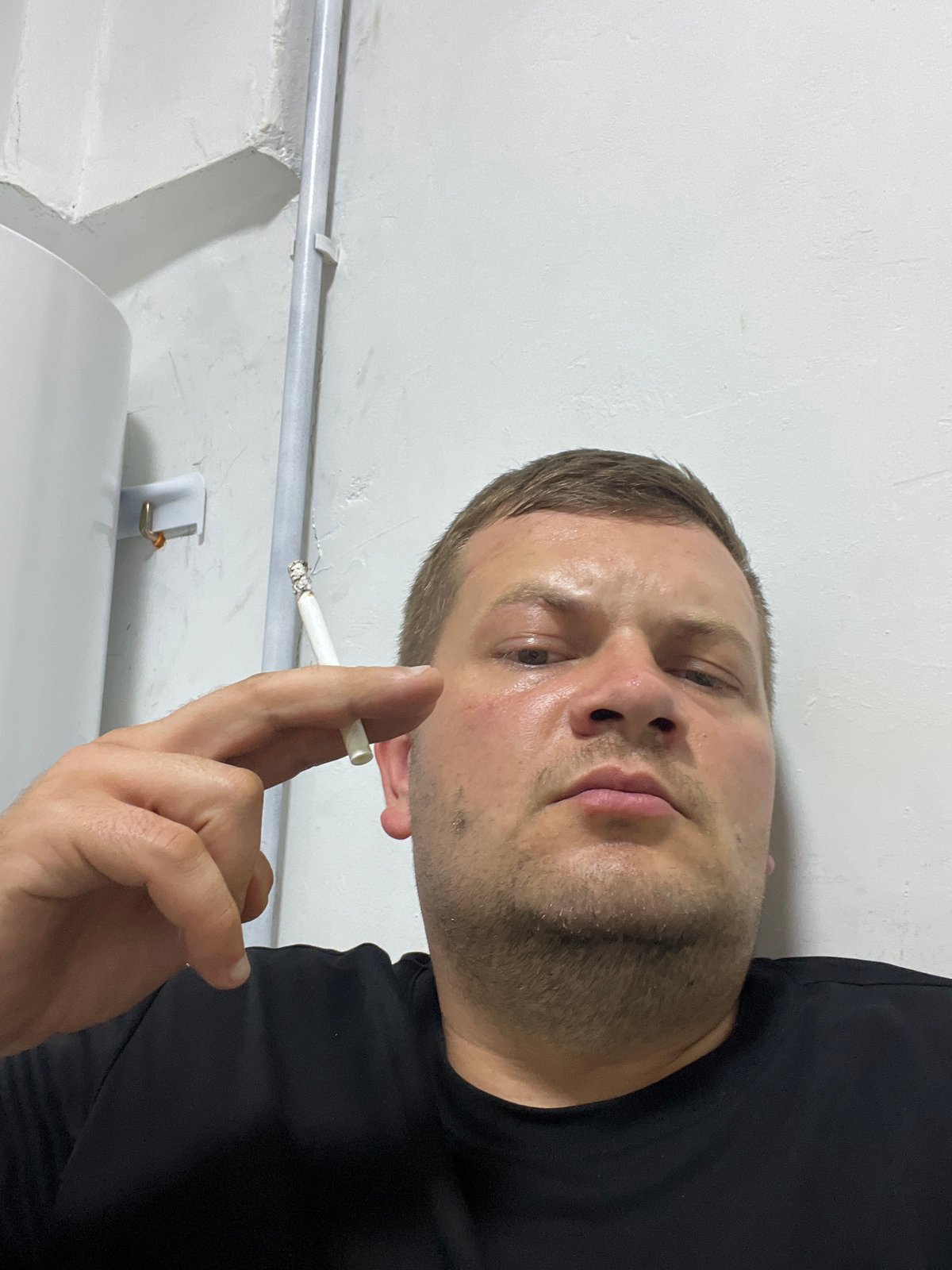 Lit cigarette held close-up in Baku
