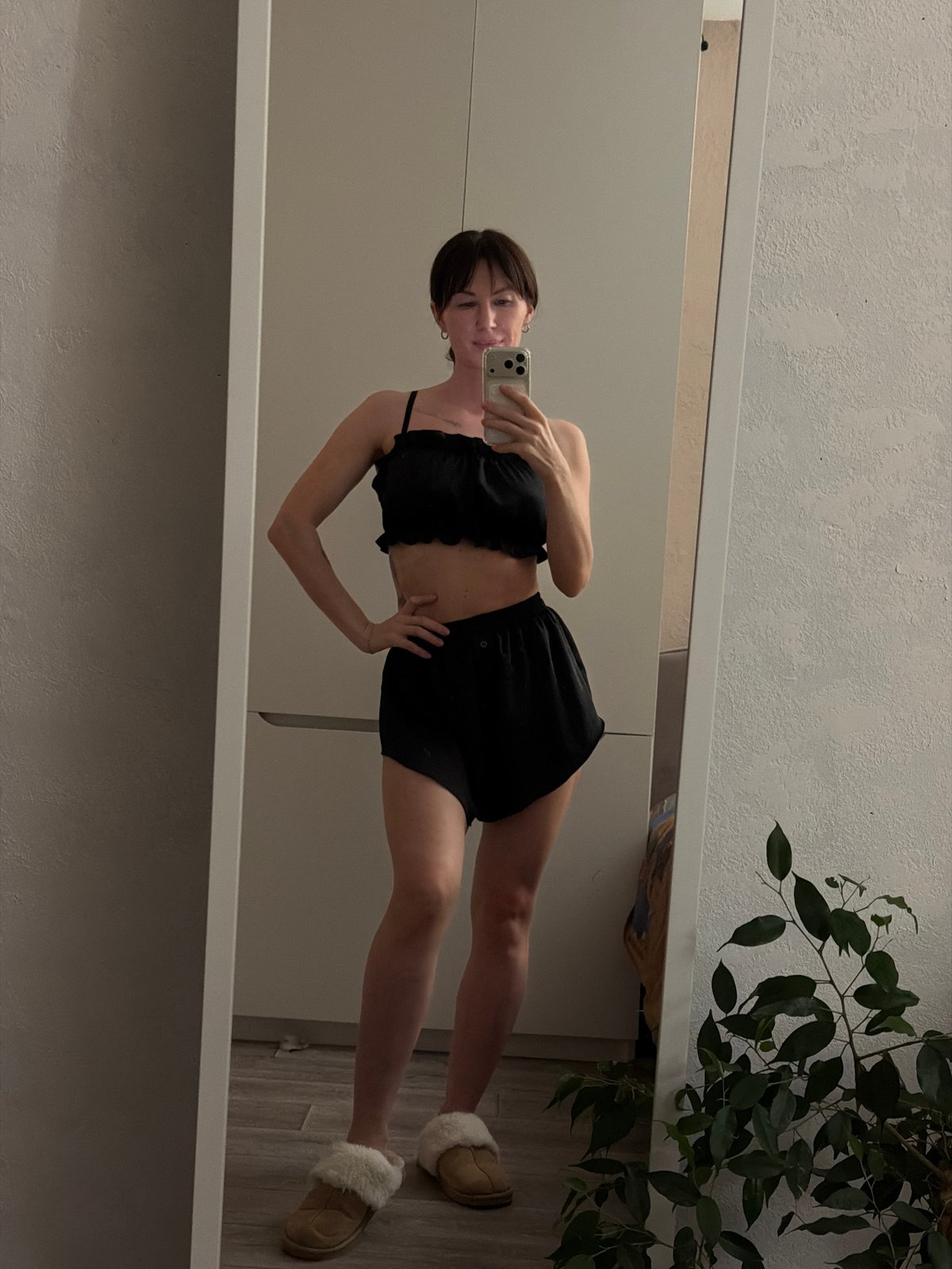 Woman takes mirror selfies in black outfit, Perm apartment