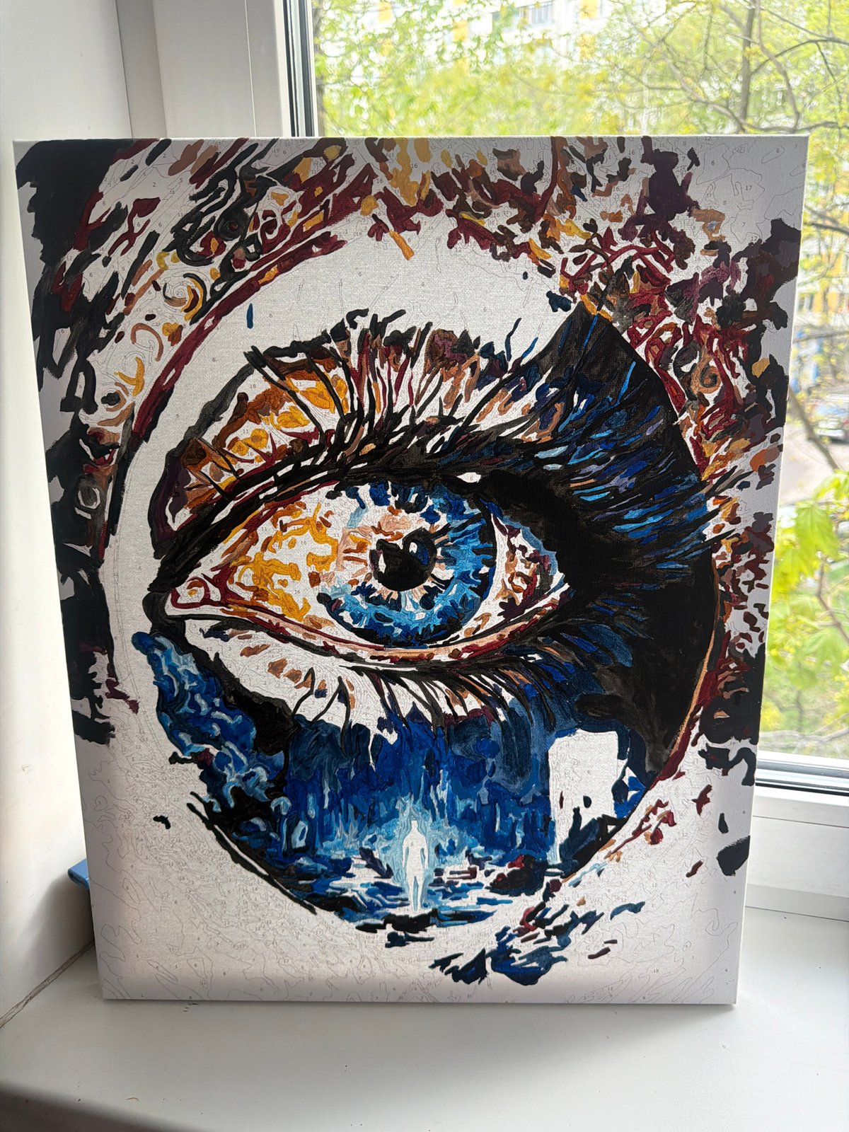 Paint-by-numbers eye artwork captured on Moscow windowsill