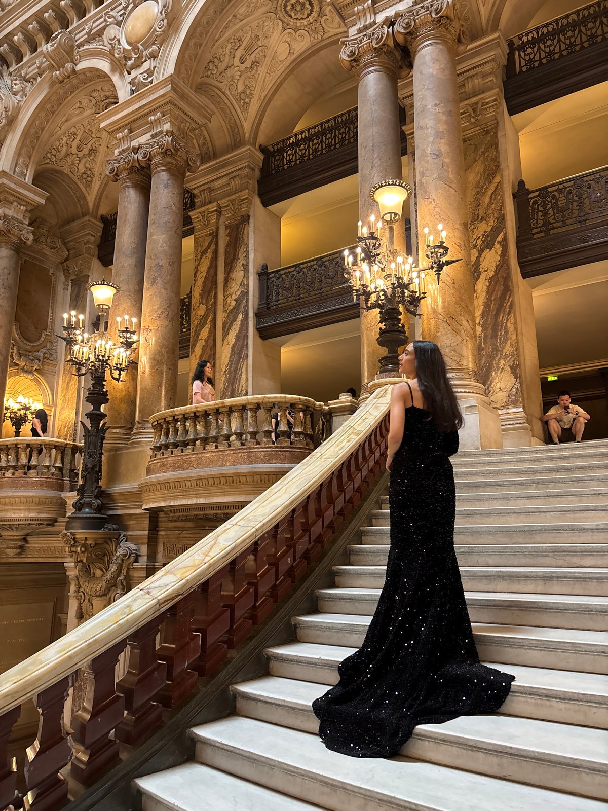 Black sequined gown on the grand staircase of Palais Garnier