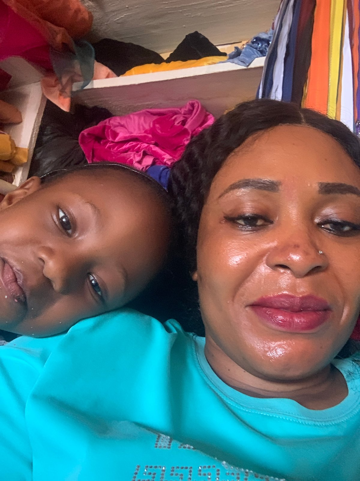 Woman takes selfies at fabric shop in Nigeria