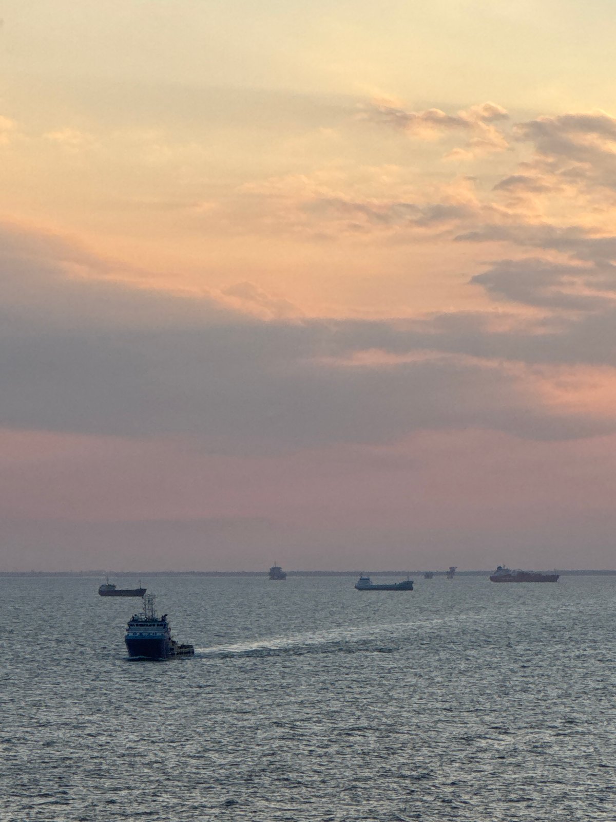 Maritime industrial activity observed off Italian coast during sunset
