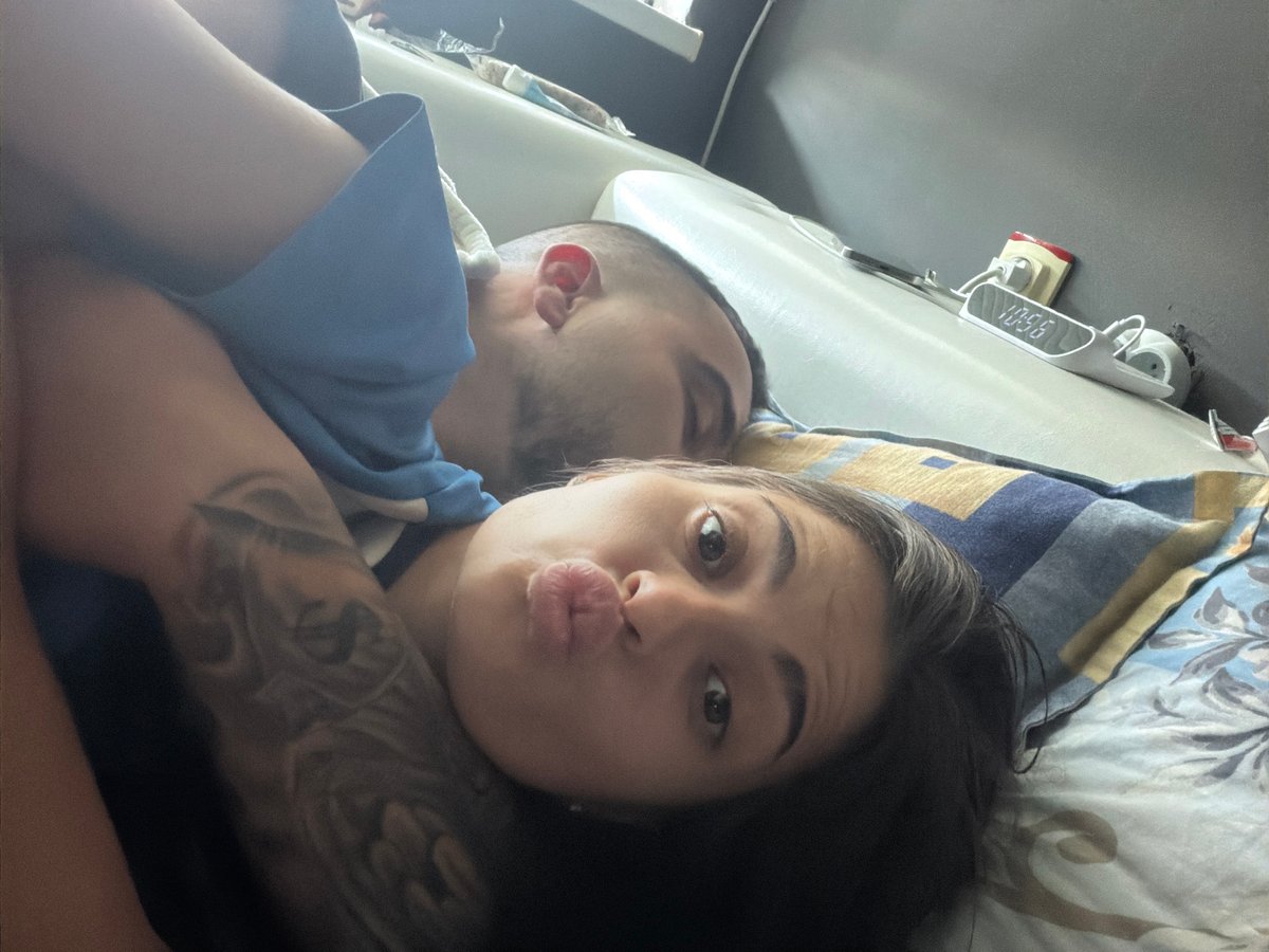 Couple captures intimate bedroom selfie moment together