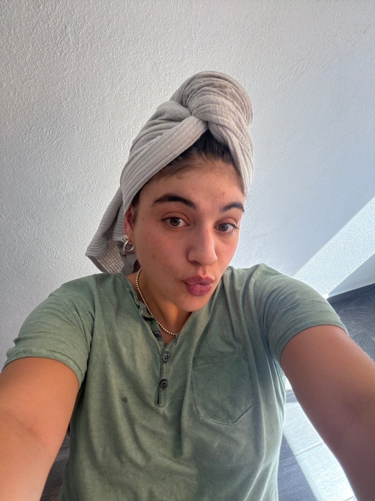 Woman takes post-shower selfie in Puebla home