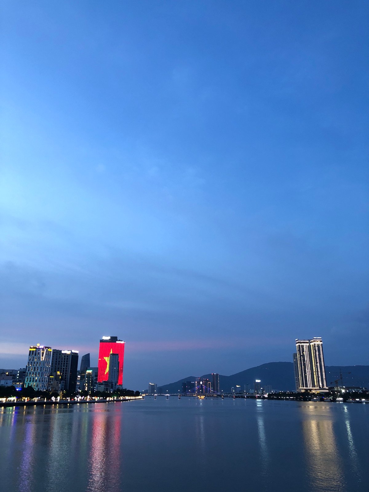 Da Nang's Dragon Bridge lit up along the river at night