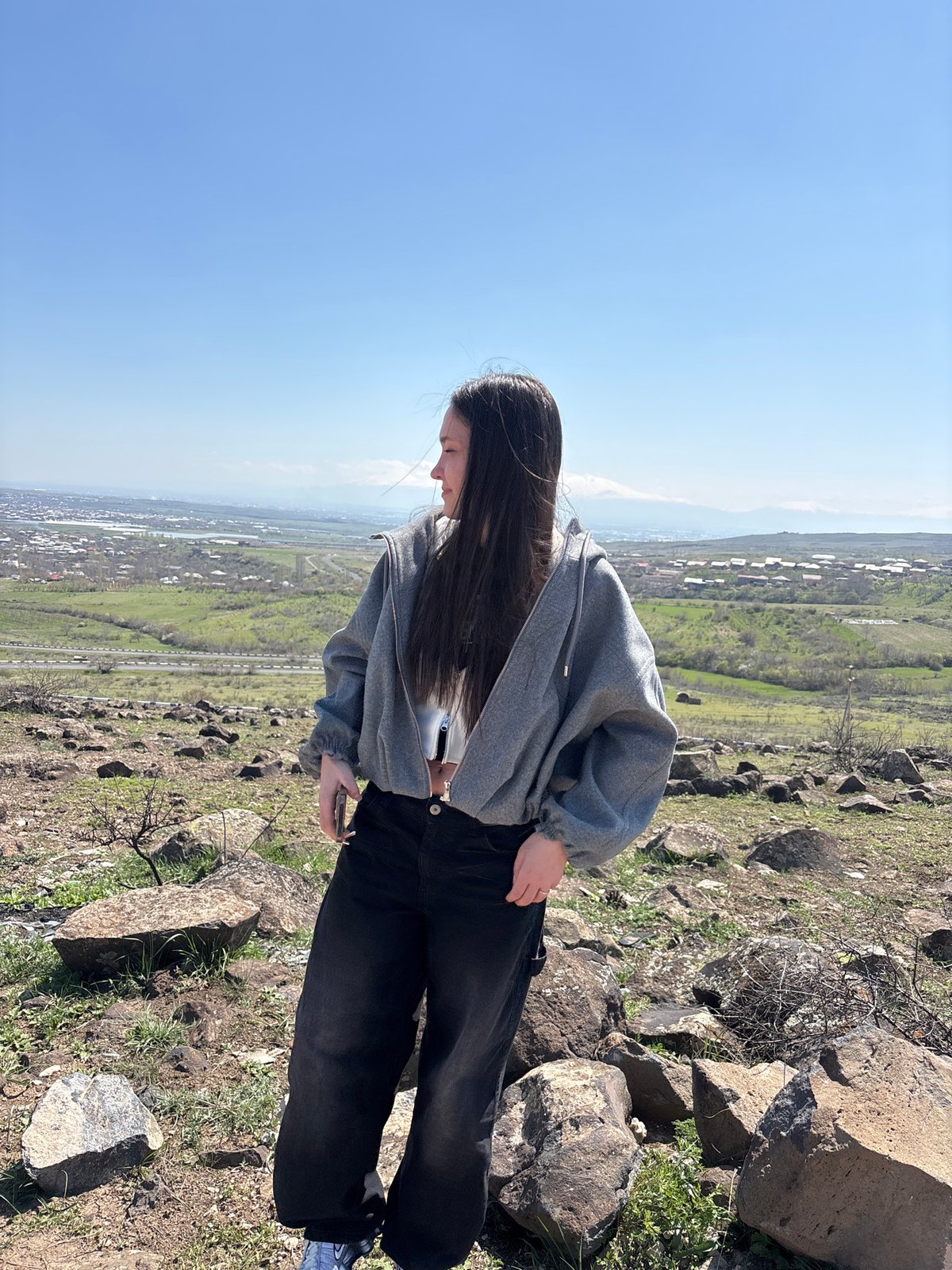 Tourists pose for photos on Byurakan hillside overlooking Armenia
